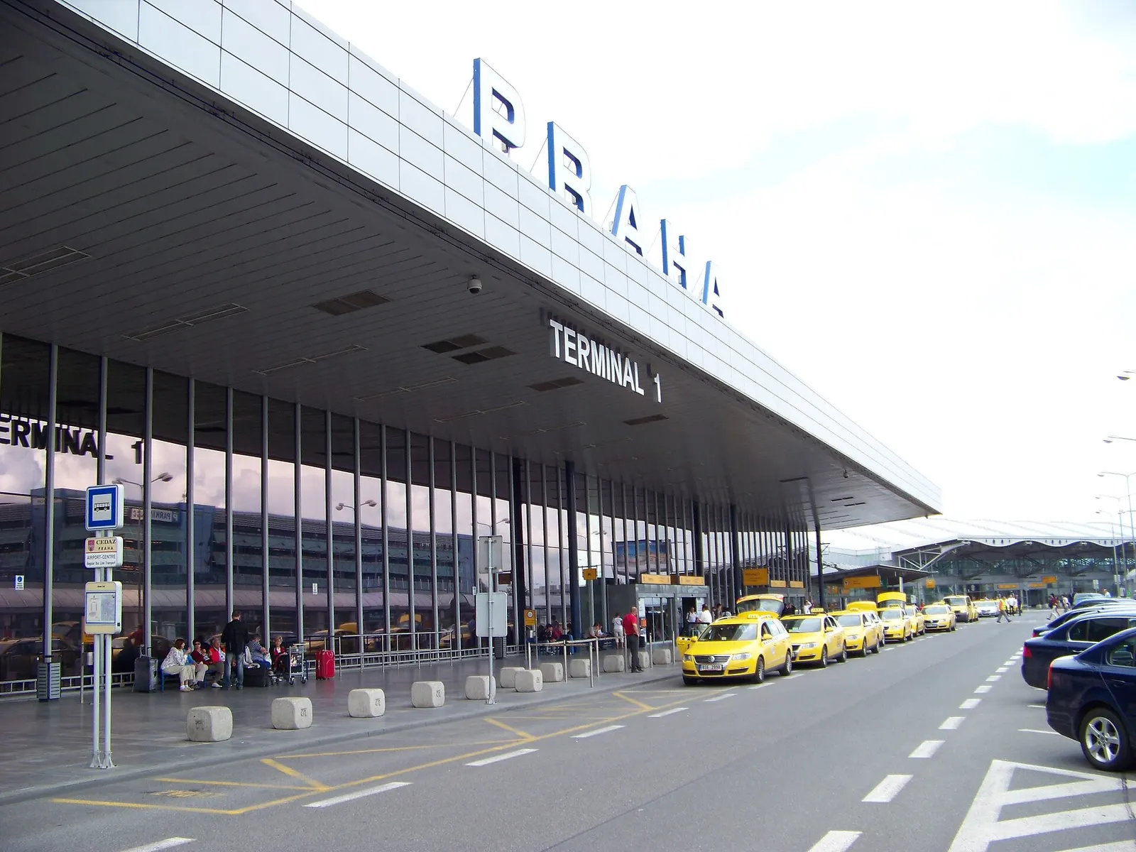 Prague - Ruzyně , the Czech Republic . Airport, terminal 1, bus stop of CEDAZ and a taxicab stand.