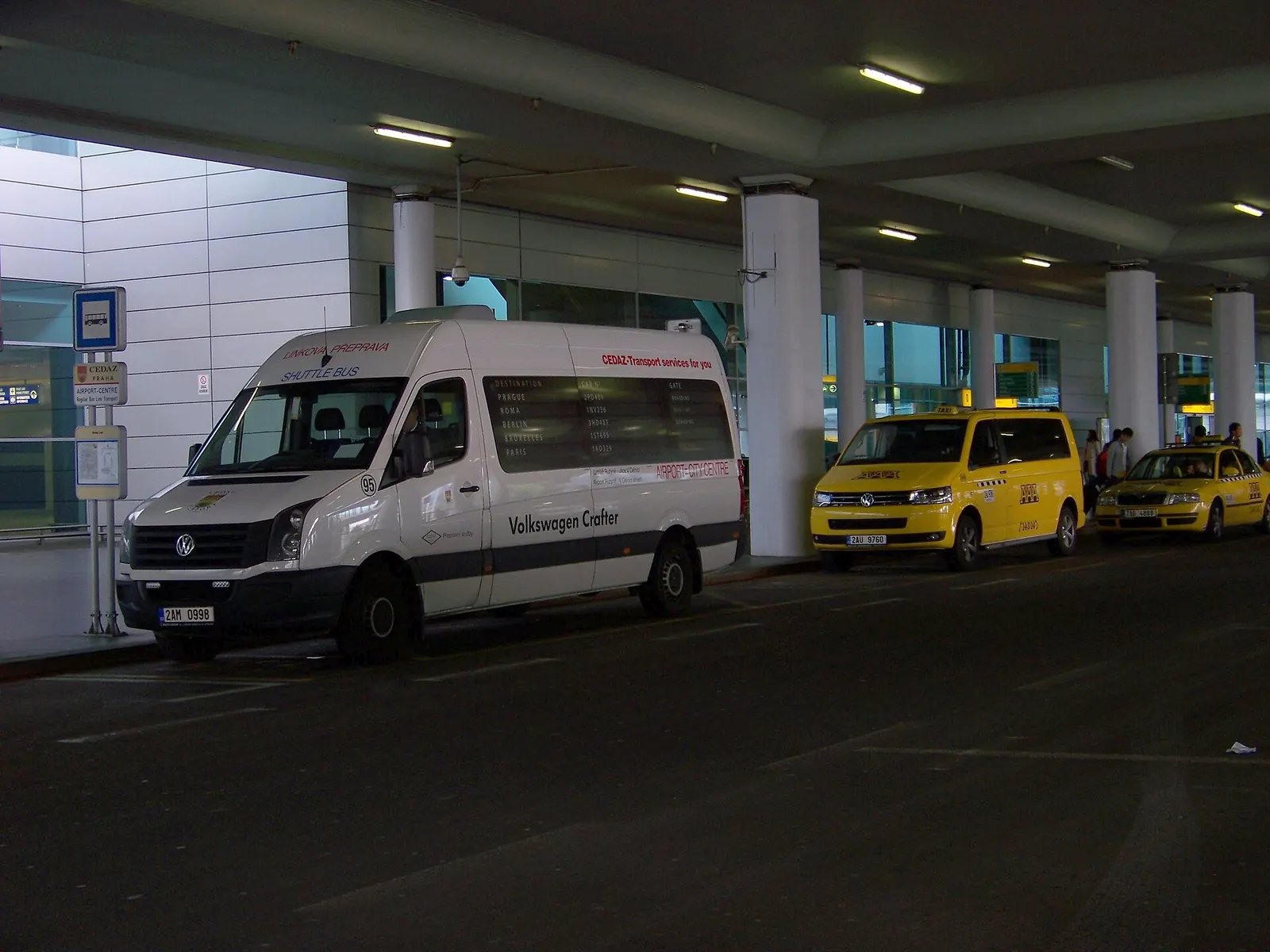 Prague - Ruzyně , the Czech Republic . The Airport, terminal 2, a minibus of CEDAZ and taxicabs.