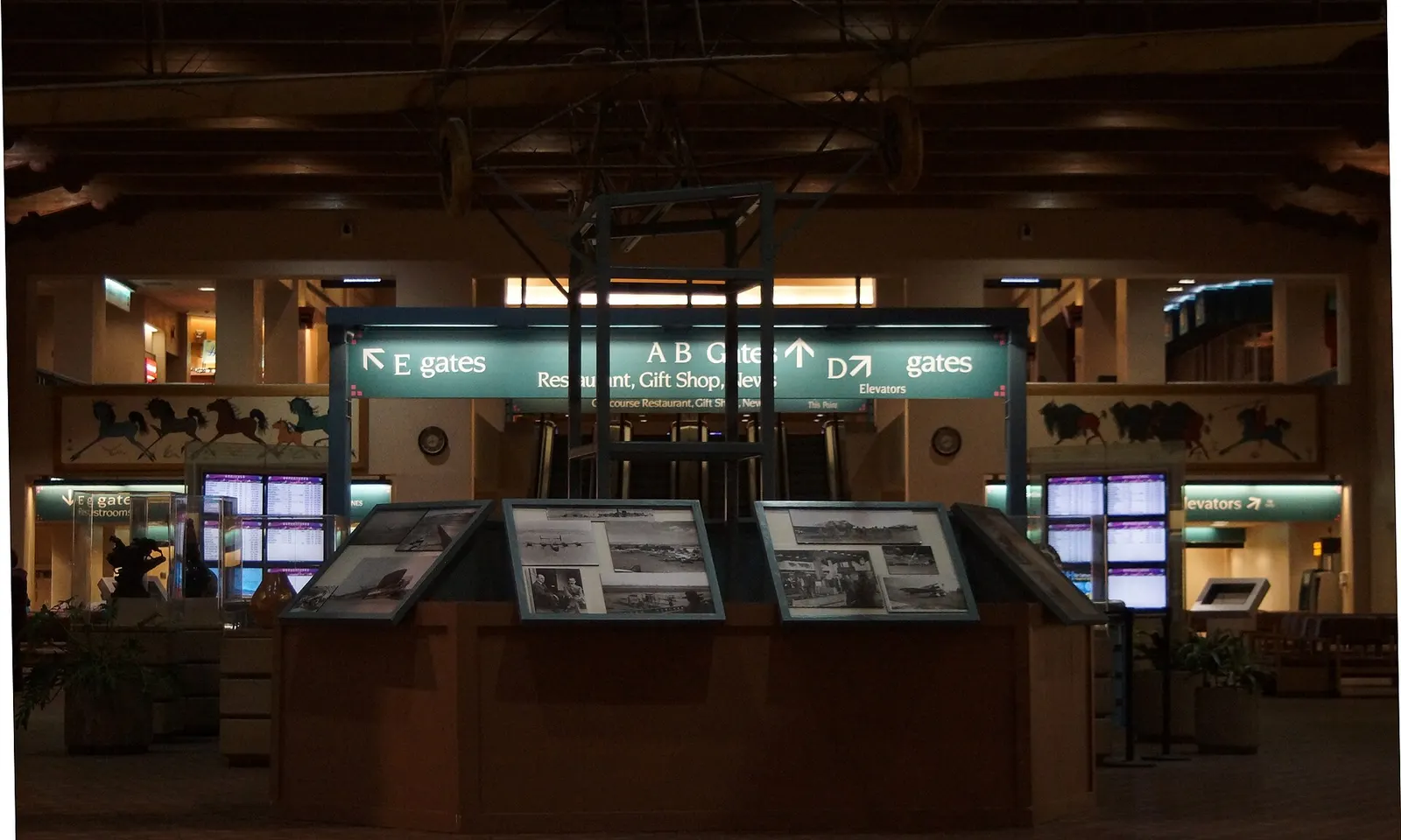 Great Hall interior at Albuquerque International Sunport showing the hanging Ingraham-Foster biplane over the open terminal floor.