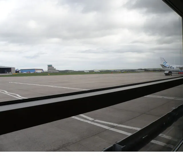 View from inside Aberdeen Airport’s passenger terminal looking across the apron toward the control tower.