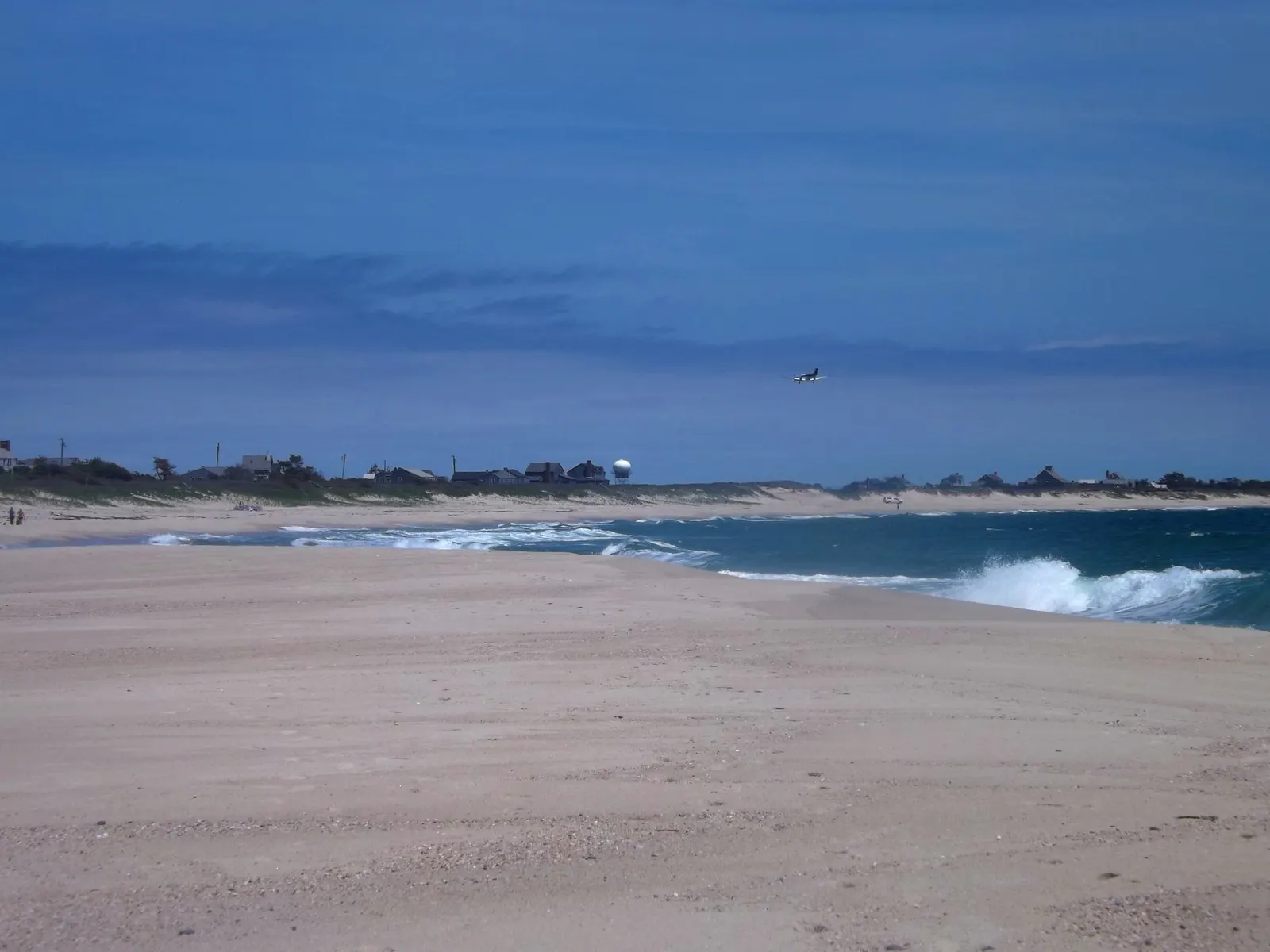 A plane coming in for a landing at Nantucket Memorial Airport, viewed from Surfside Beach.
