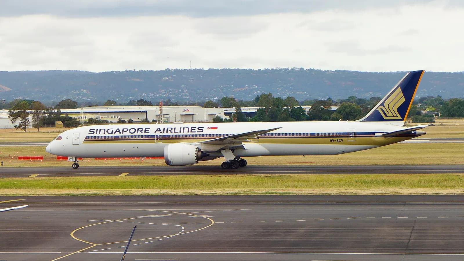 Singapore Airlines Boeing 787-10 9V-SCV taxiing to the terminal at Adelaide Airport (ADL/YPAD), South Australia, at the end of a flight from Singapore (SIN/WSSS) as SQ277 – photo taken from inside the terminal