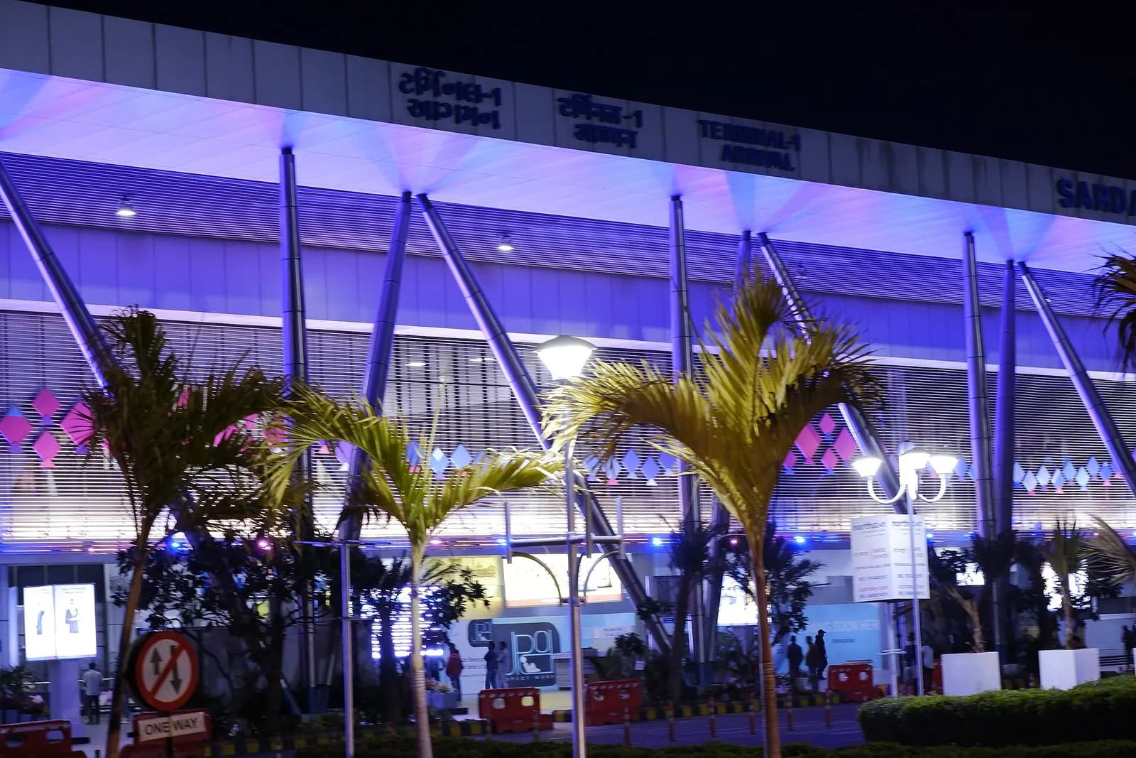 Night exterior of Terminal 1 arrivals canopy at Sardar Vallabhbhai Patel International Airport