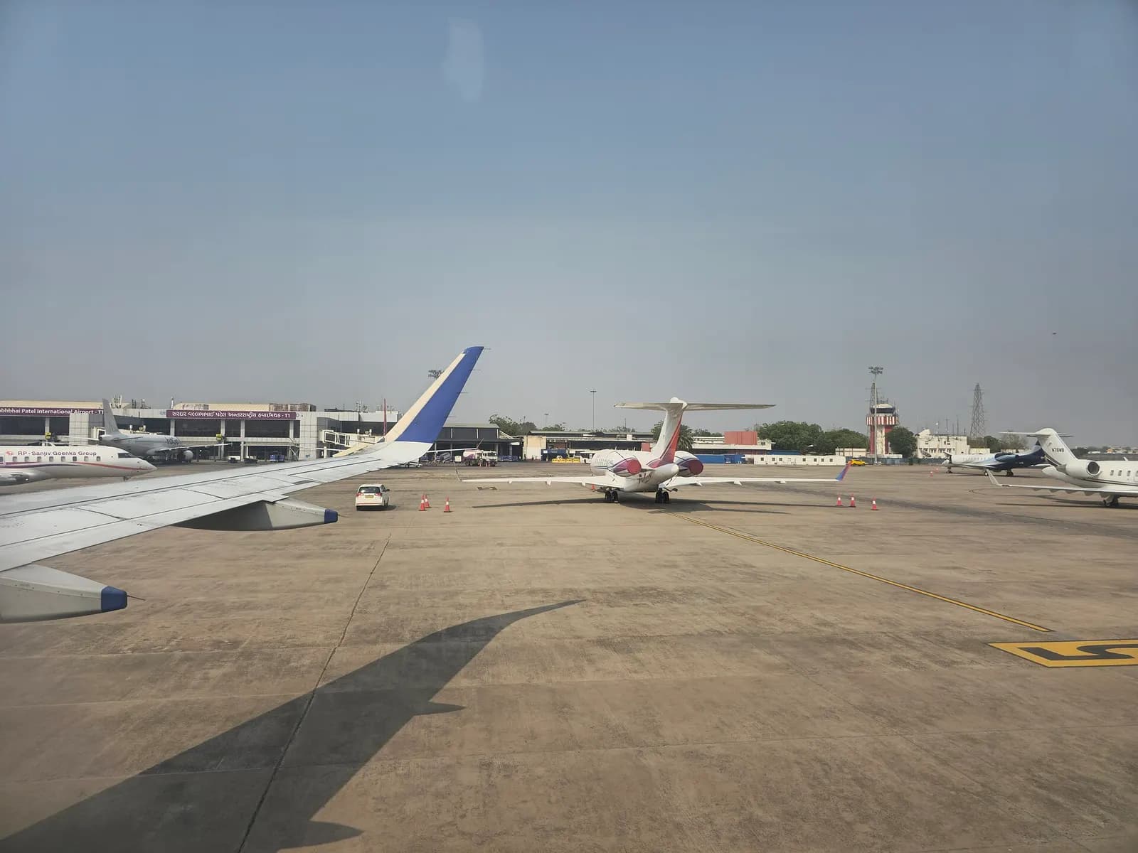 Apron view toward Sardar Vallabhbhai Patel International Airport terminal with airport name visible