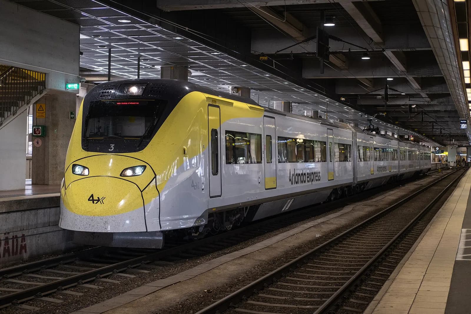 A silver Arlanda Express train waiting at Stockholm Central Station on the platform bound for Arlanda Airport.