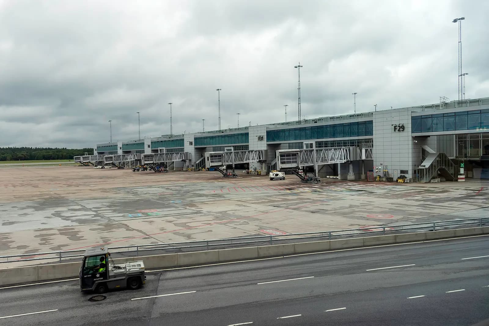 Exterior of Terminal 5 at Stockholm Arlanda Airport, with its long glass facade and entrance area in daylight.