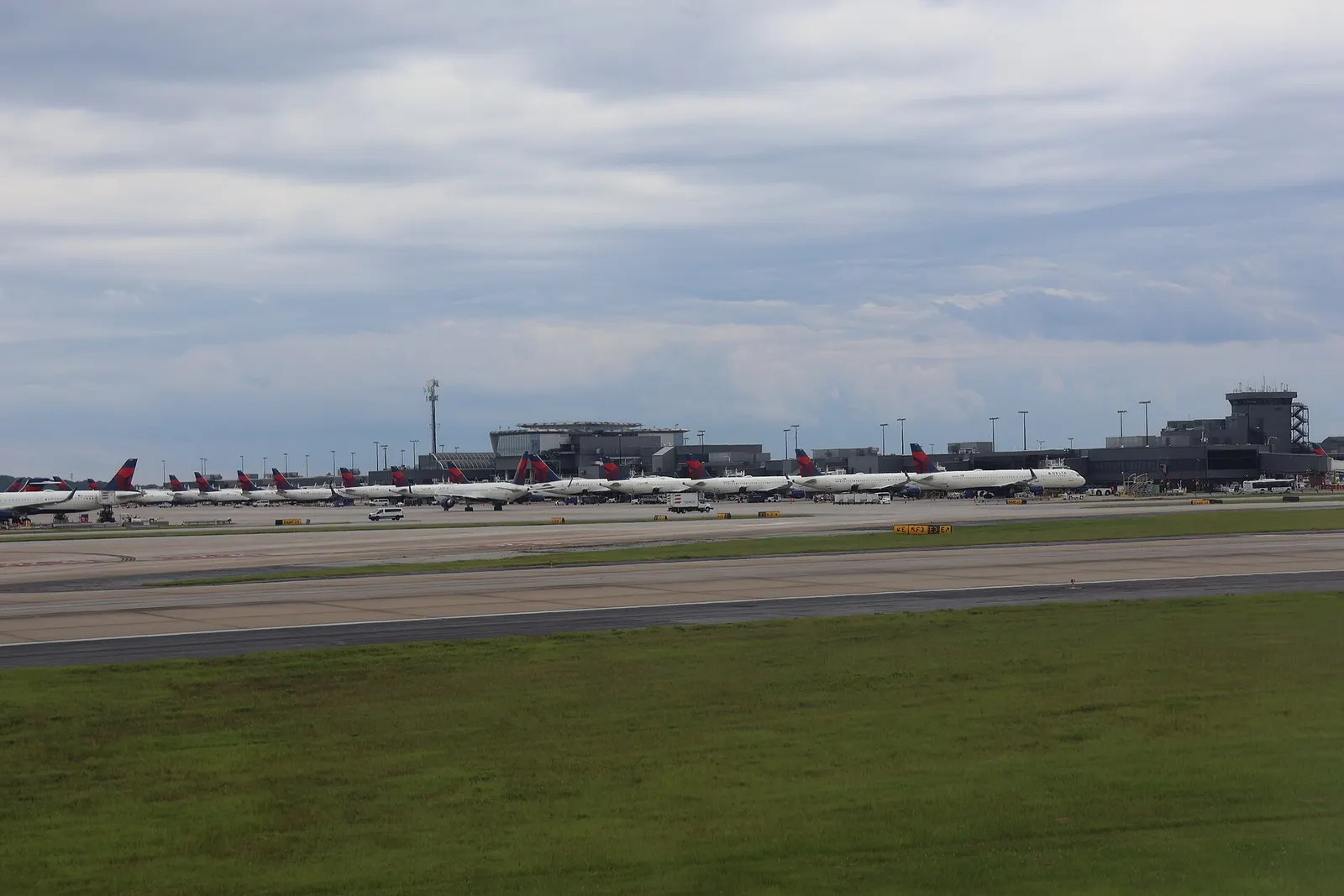 Aerial view of Hartsfield-Jackson Atlanta International Airport's parallel runways, midfield concourses, and terminal buildings seen from an arriving Virgin Atlantic flight.