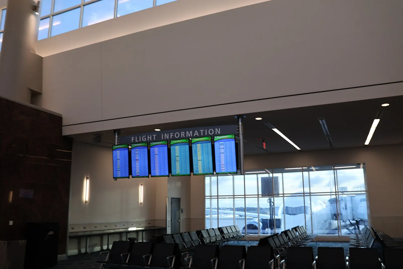 International departures corridor in Concourse F at Hartsfield-Jackson Atlanta International Airport with wide walkways, flight information displays, and waiting passengers.