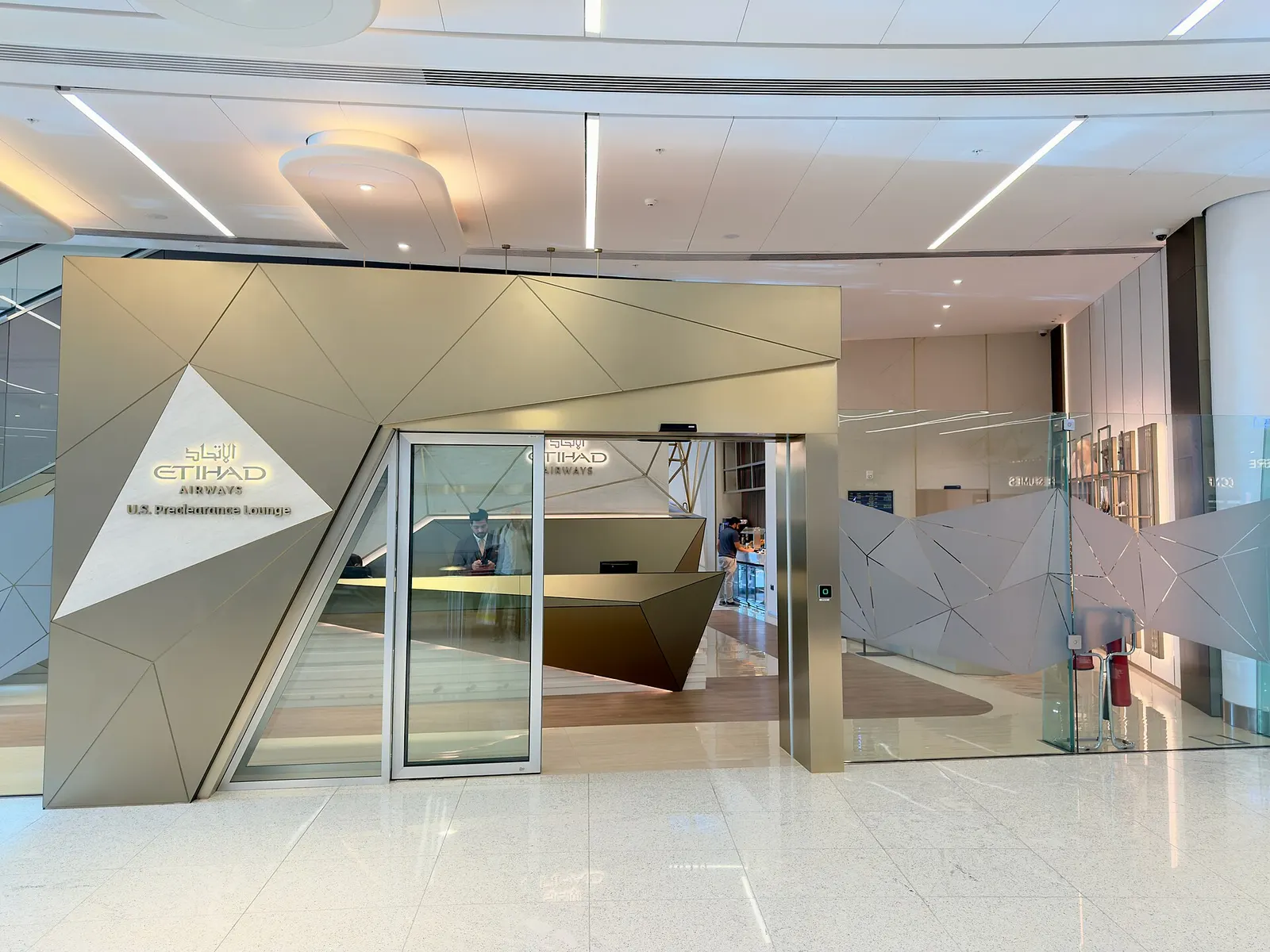 The U.S. Preclearance Lounge at Zayed International Airport, with seating areas, service counters, and U.S. border preclearance signage.
