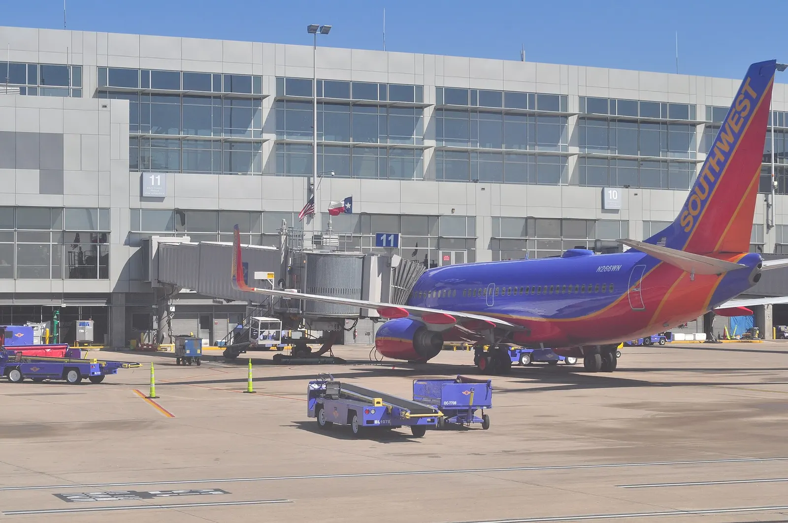 Commercial airliner parked at a jet bridge gate outside the Barbara Jordan Terminal at Austin–Bergstrom International Airport.