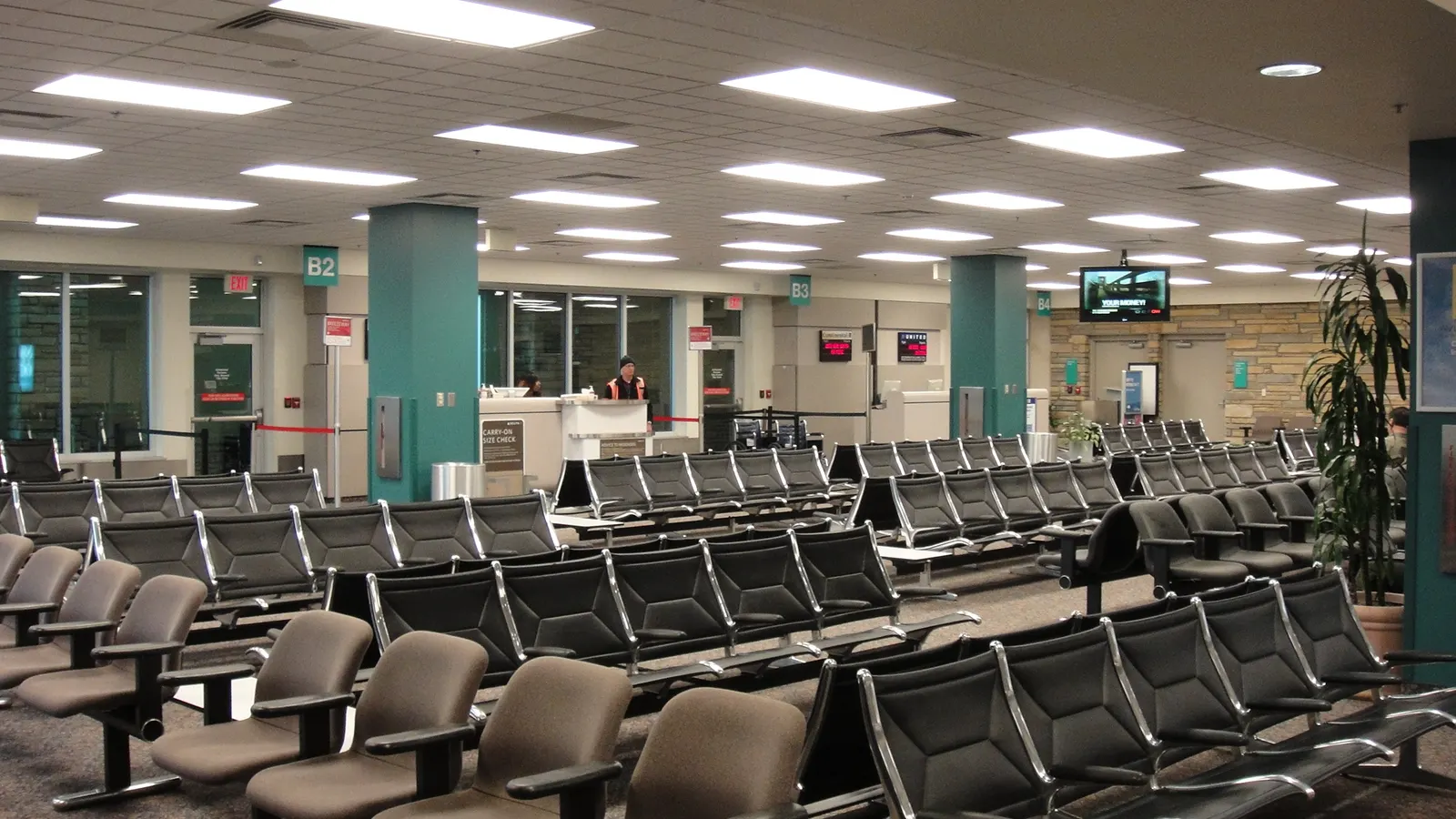 2010 Asheville Regional Airport holdroom with rows of seats and old gate letters B2 and B3 on the columns.