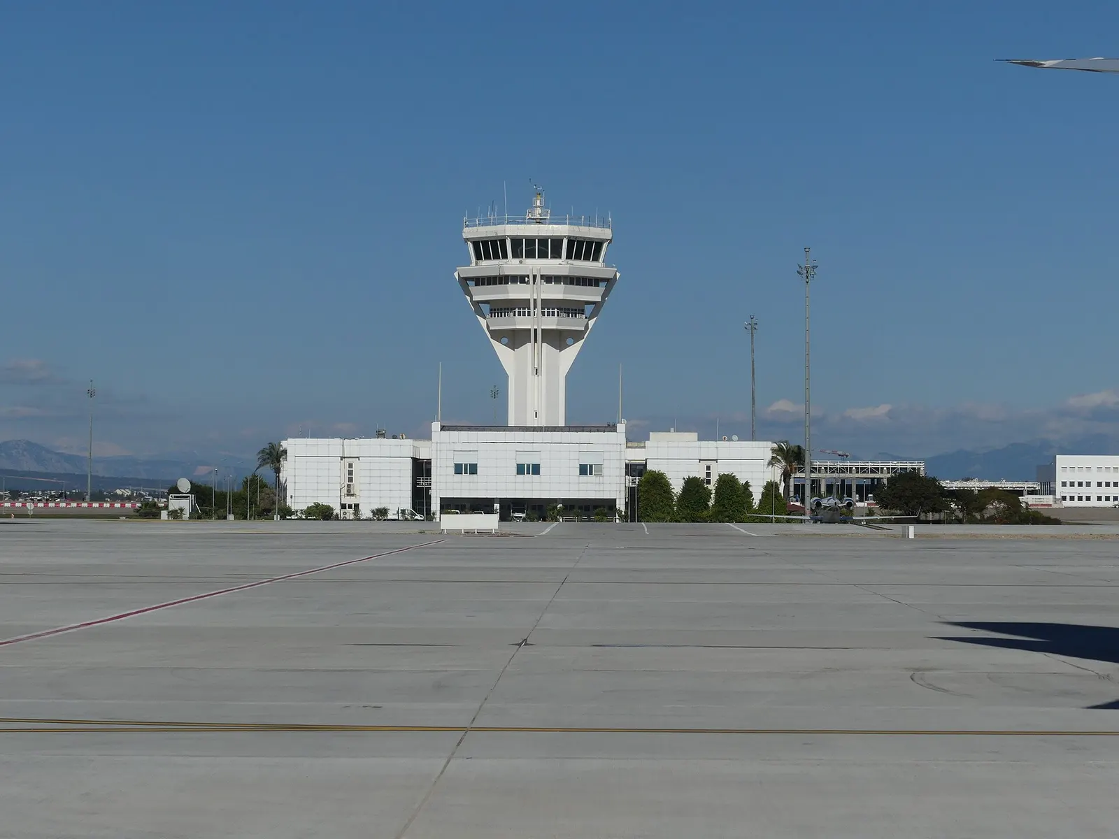 Antalya Airport control tower and apron with Taurus Mountains behind