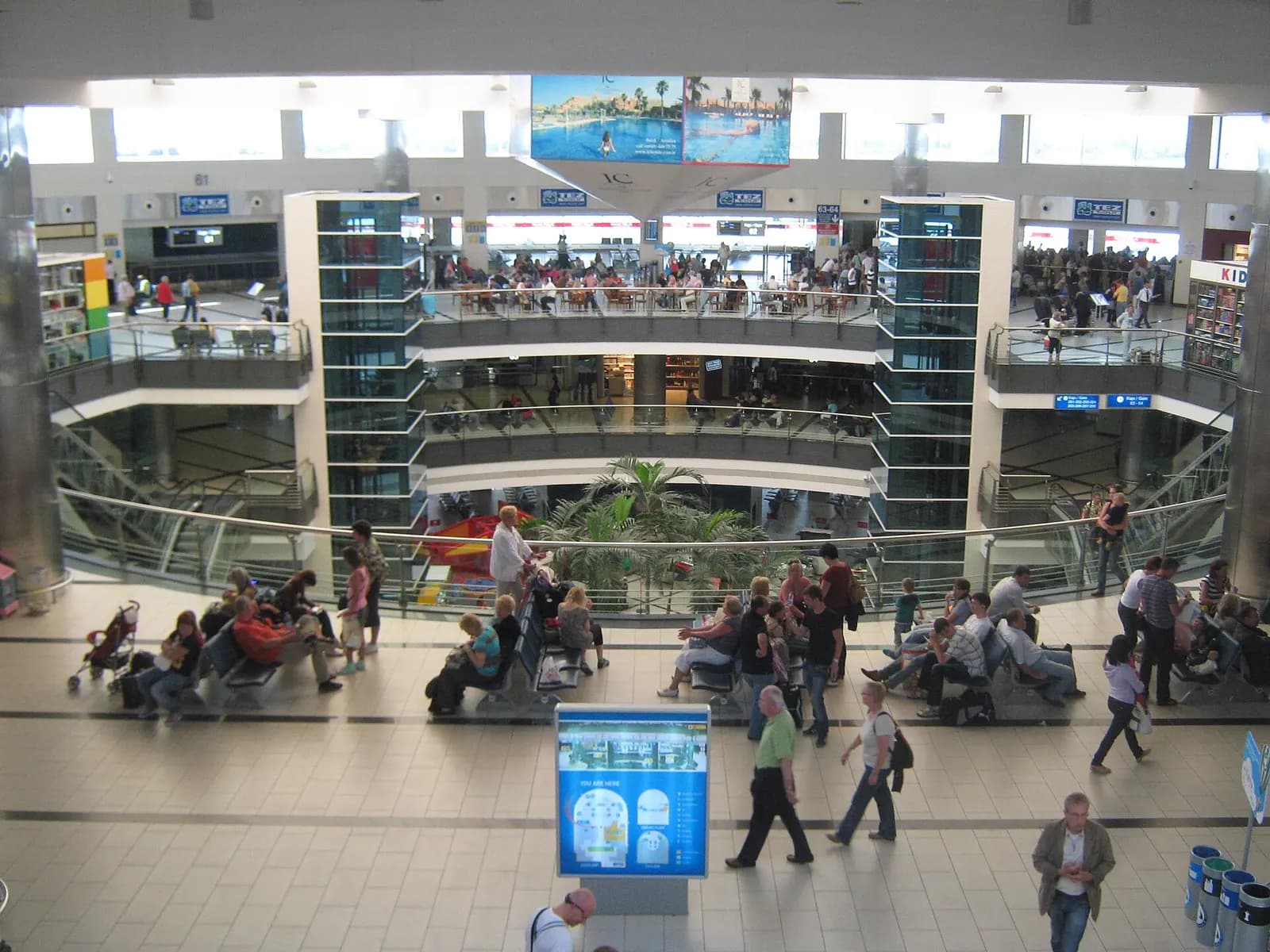 Multi-level Antalya Terminal 2 atrium with gate signs and Tez Tour counters