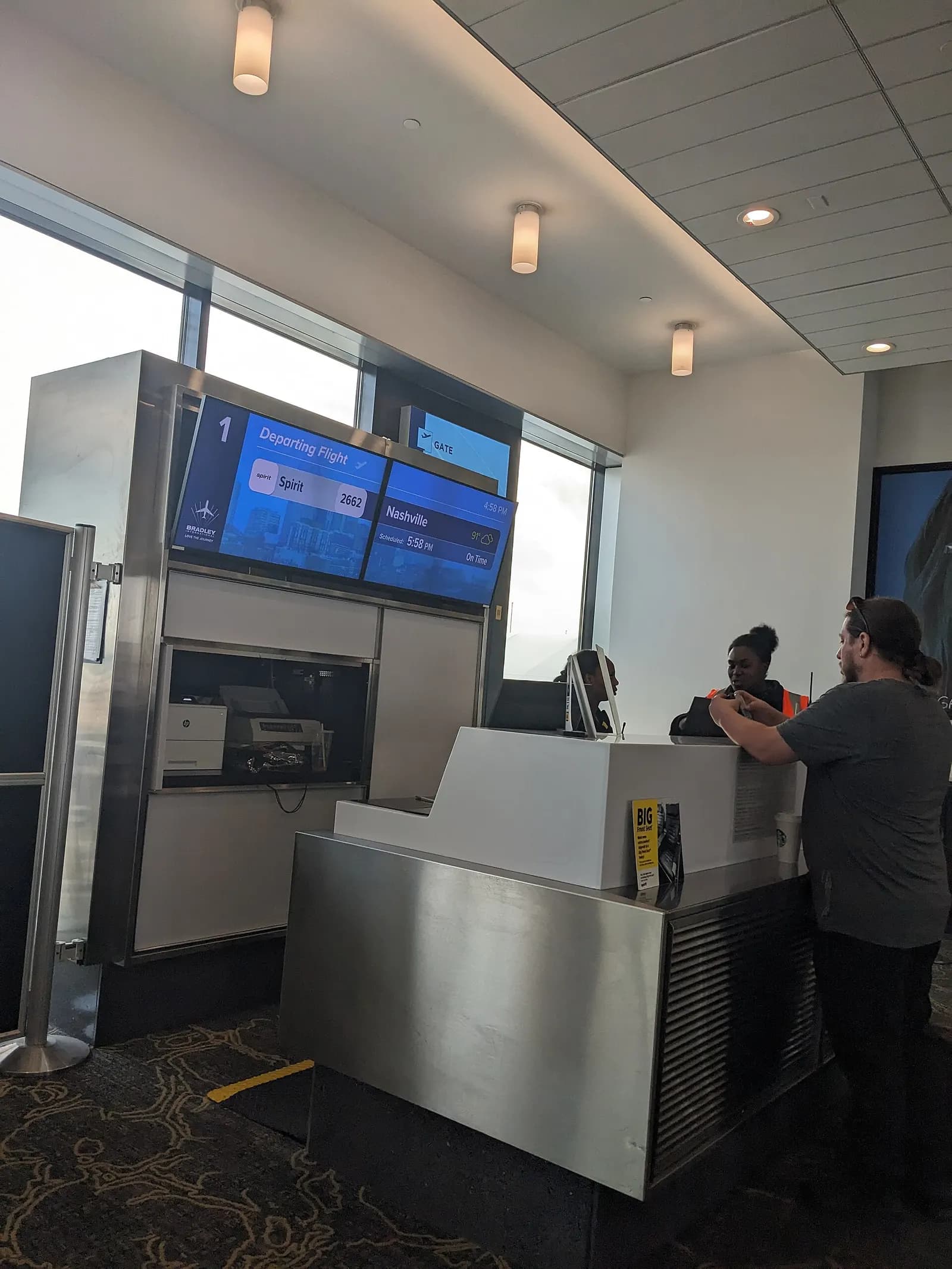 Gate 1 counter at Bradley International Airport with the Love the Journey logo on the flight display