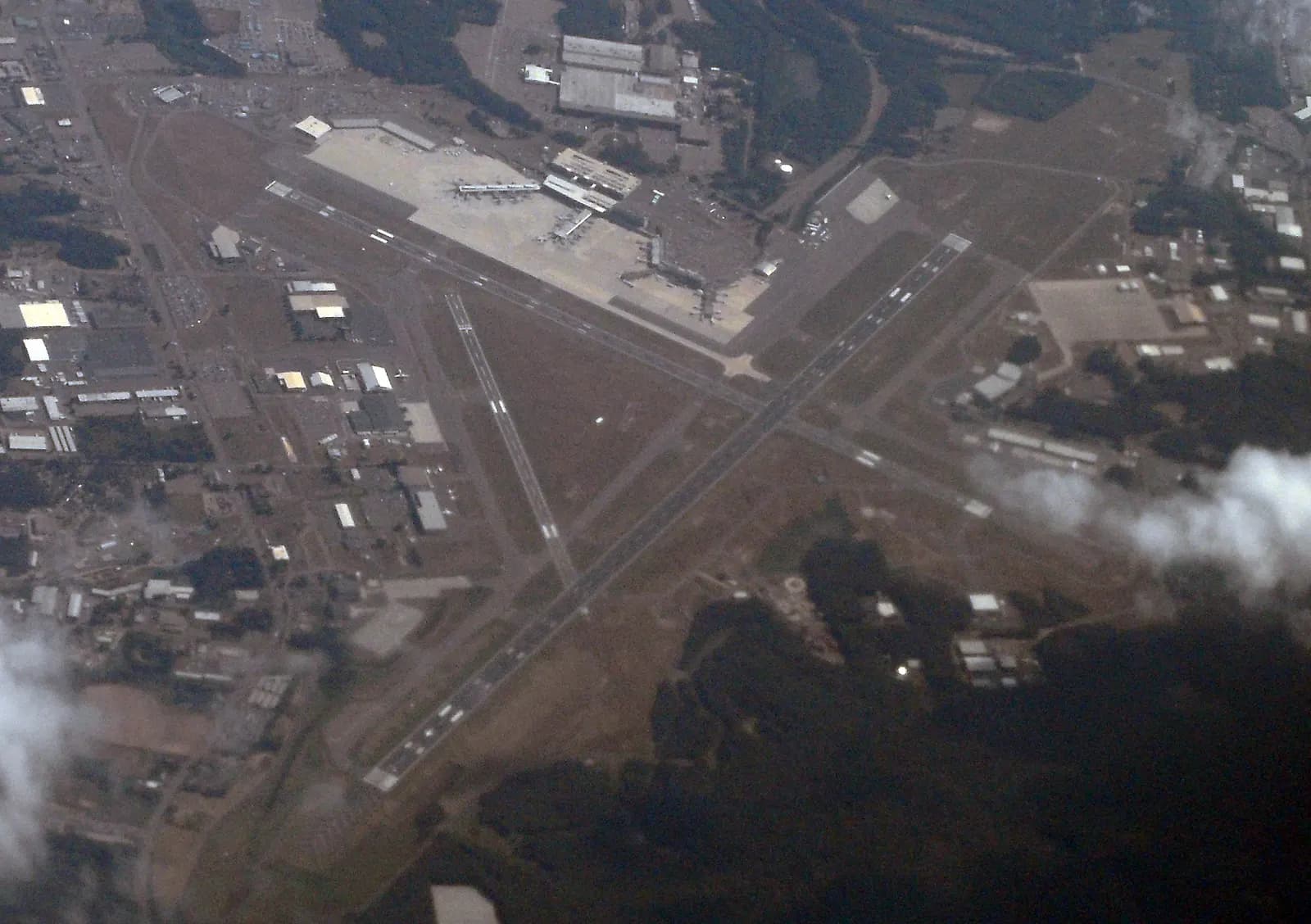 Aerial of Bradley International Airport showing the crossing runways and two-pier Terminal A
