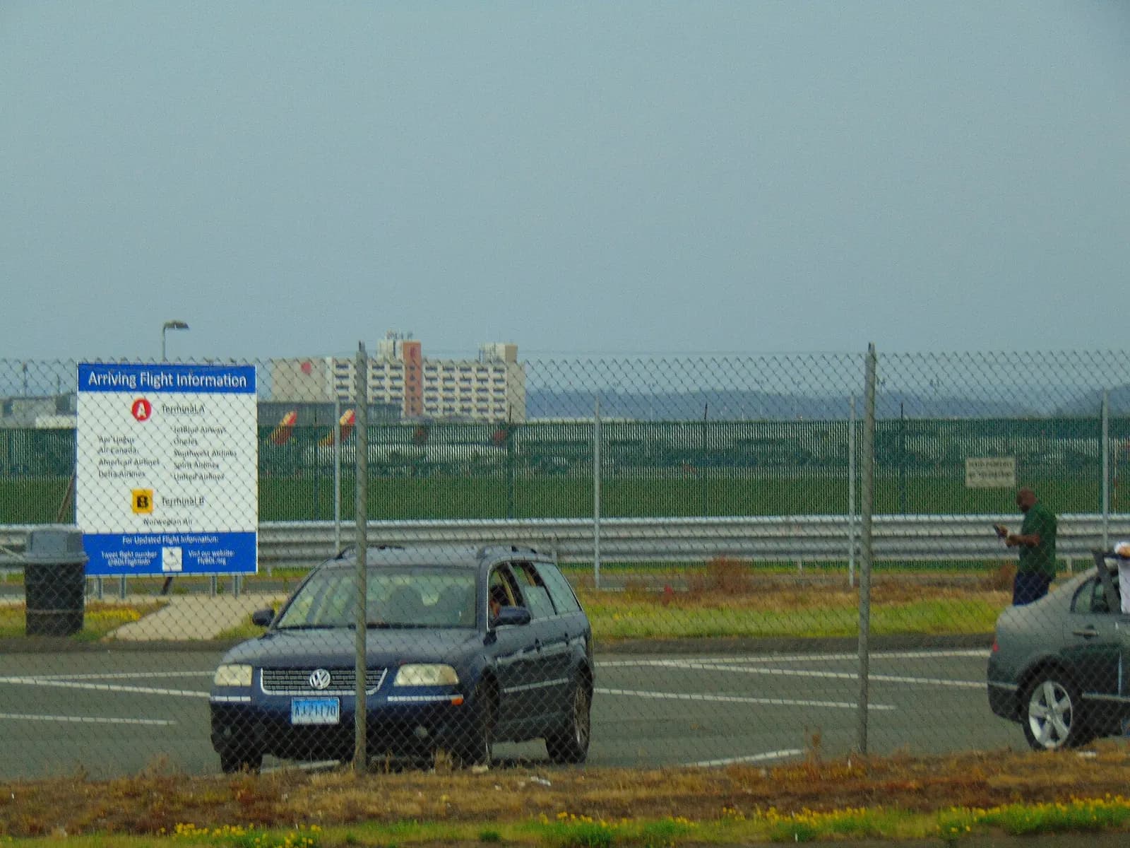 Bradley apron with an American Eagle jet, the attached Sheraton, and a Runway 15/33 taxiway sign