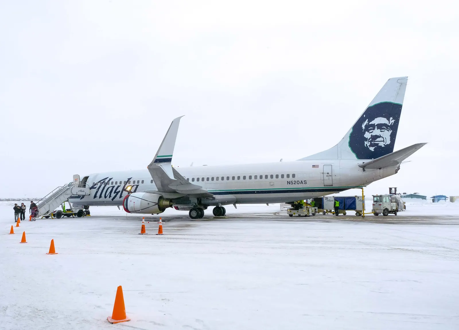 Alaska Airlines Boeing 737-800 N520AS parked at Bethel Airport while passengers and cargo come off the jet.