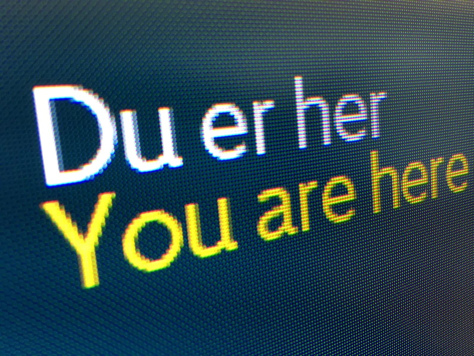 You are here (Du er her in Norwegian). Close-up of information board (RGB screen) in terminal building at Bergen Airport, Flesland, Norway. November 2017.