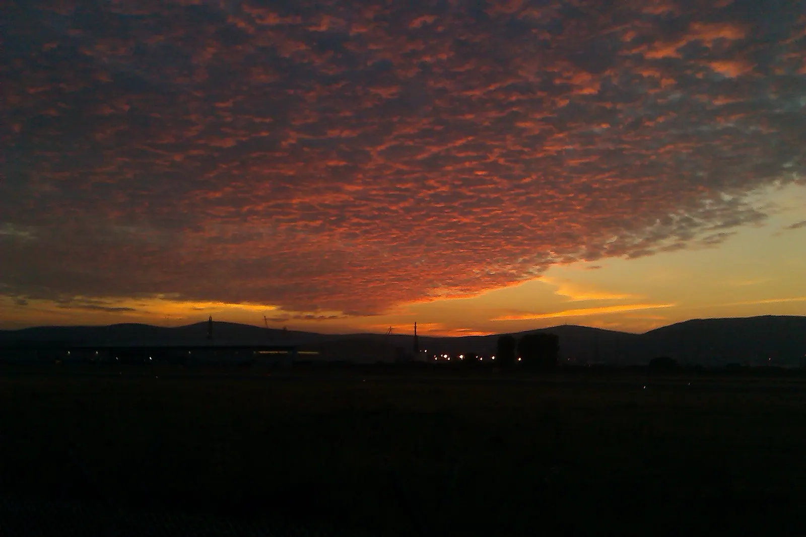 Sunset over Belfast City Airport and the docks