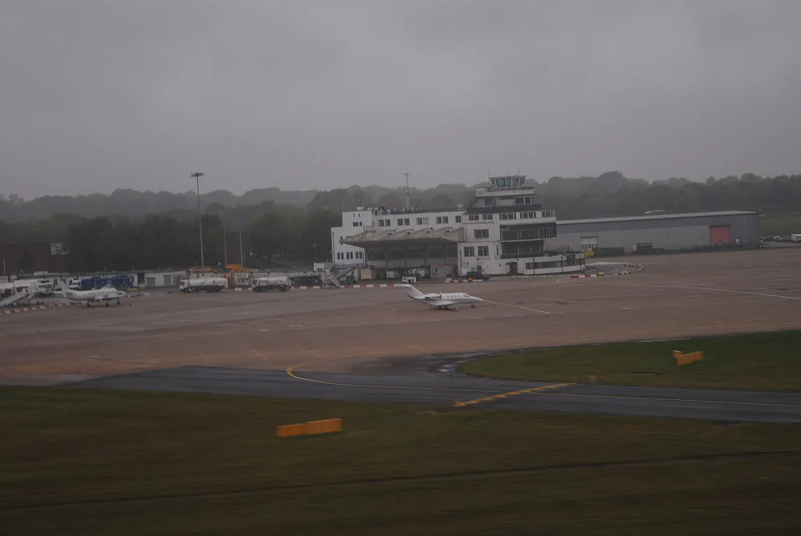 An aerial view of Birmingham Airport's terminal complex and surrounding airfield on an overcast morning.