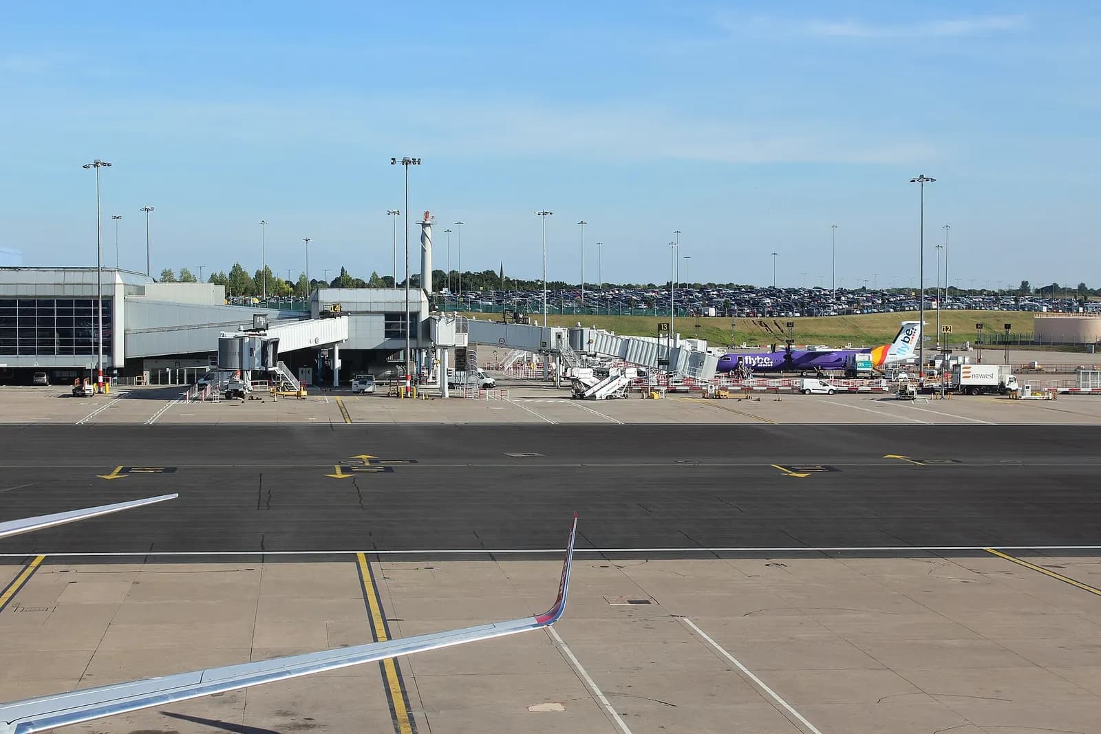 Several airbridges attached to Terminal 2 at Birmingham Airport, with aircraft parked at the stands.