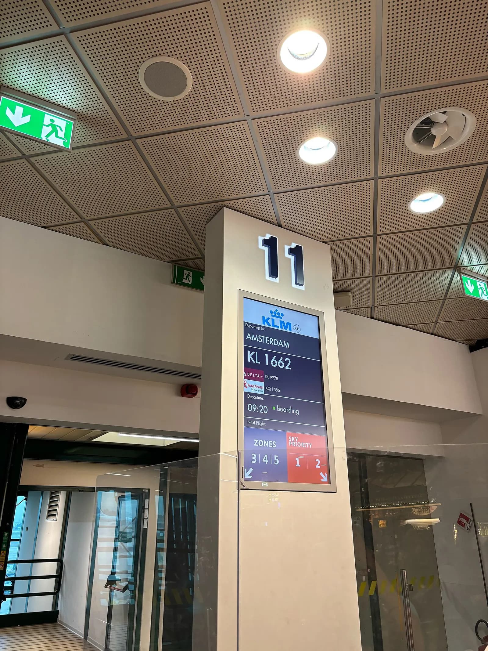 Gate boarding area at Bologna Airport with passengers waiting for an Amsterdam flight