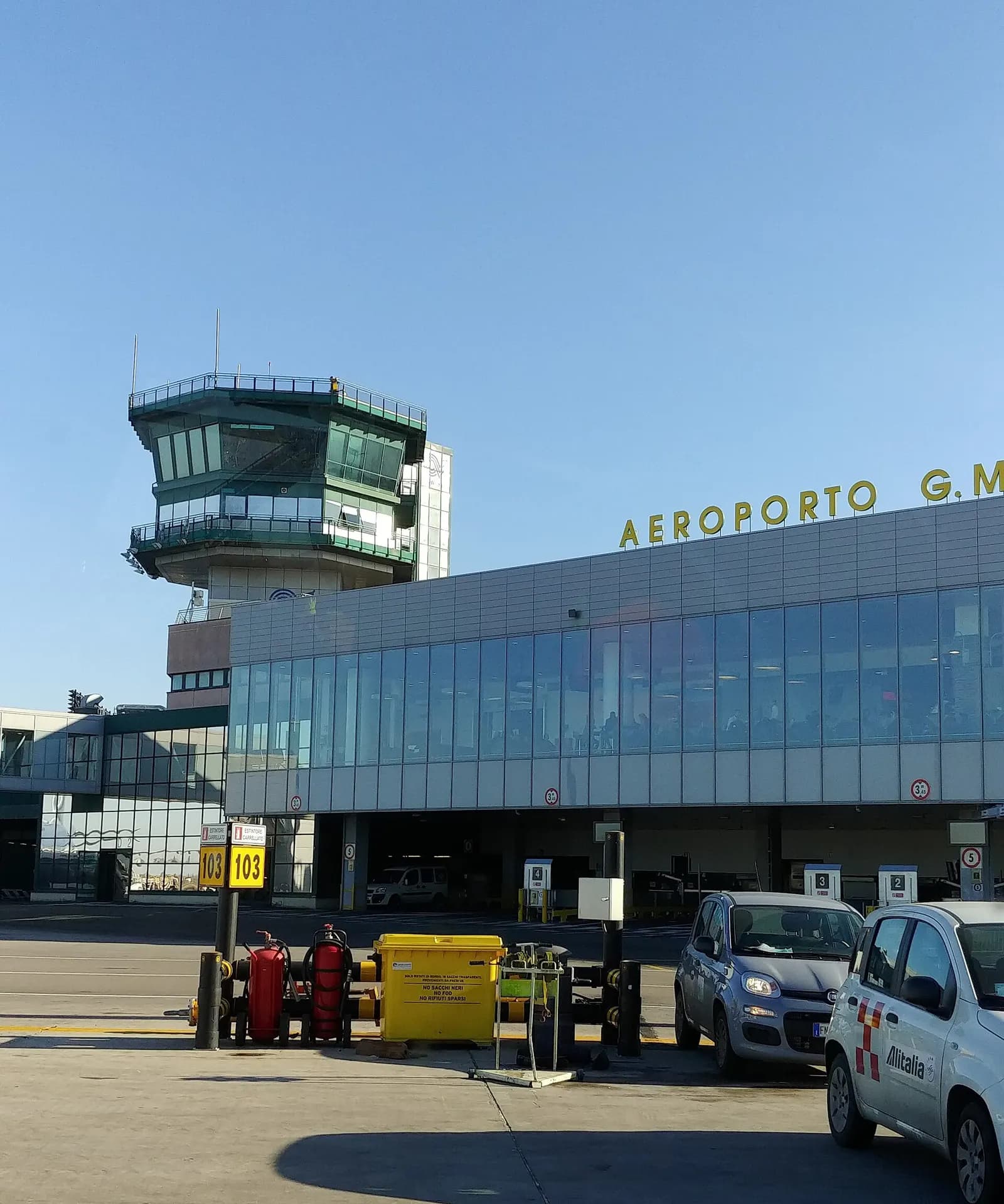 Bologna Airport passenger terminal and control tower seen from the apron