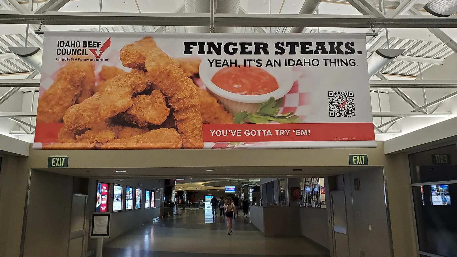Idaho Beef Council finger-steaks banner over a Boise Airport concourse corridor.