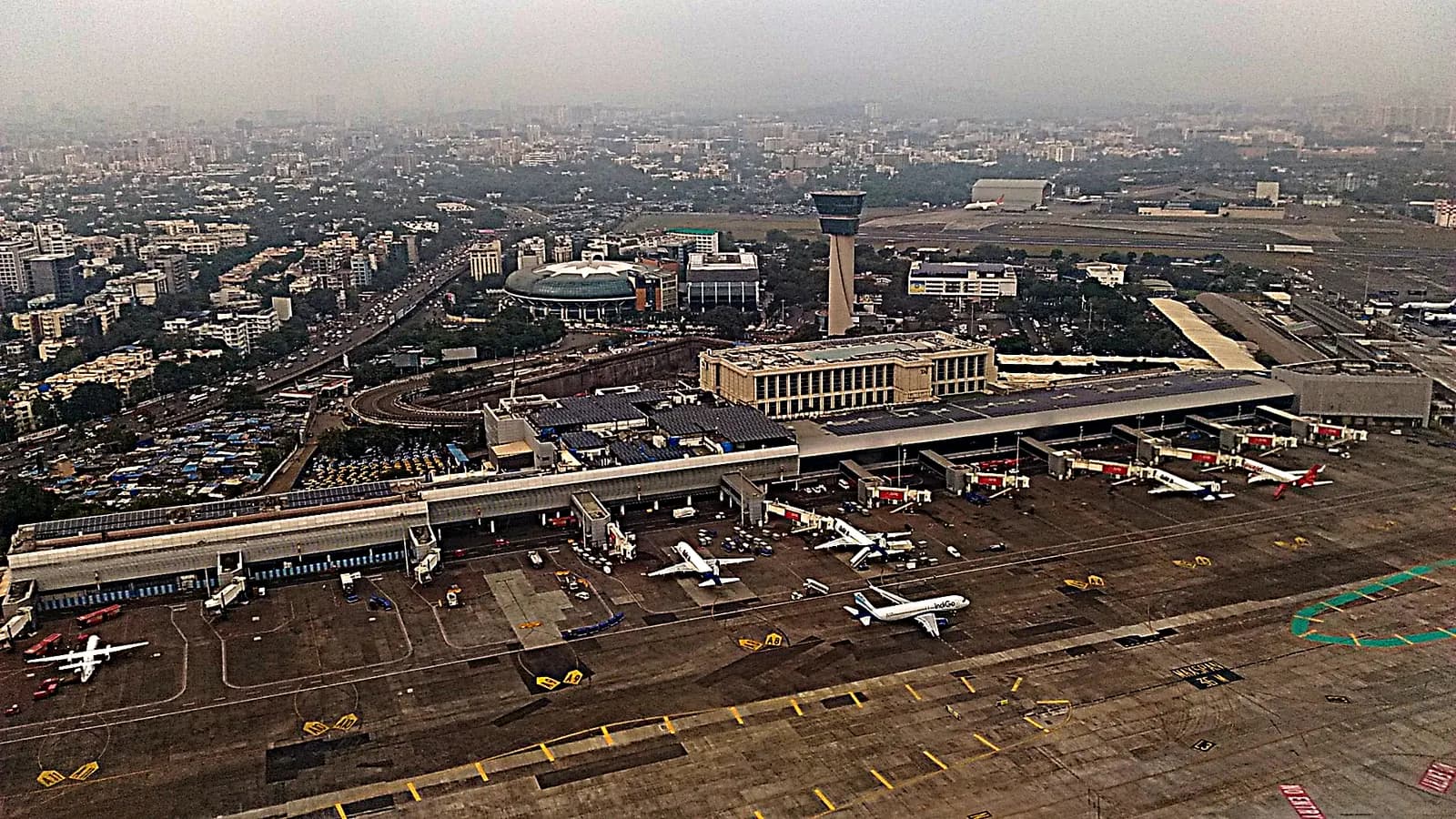 From above, Terminal 1B's retail blocks and adjacent aircraft parking areas sit next to the Sahara Star hotel on the airport's domestic side.
