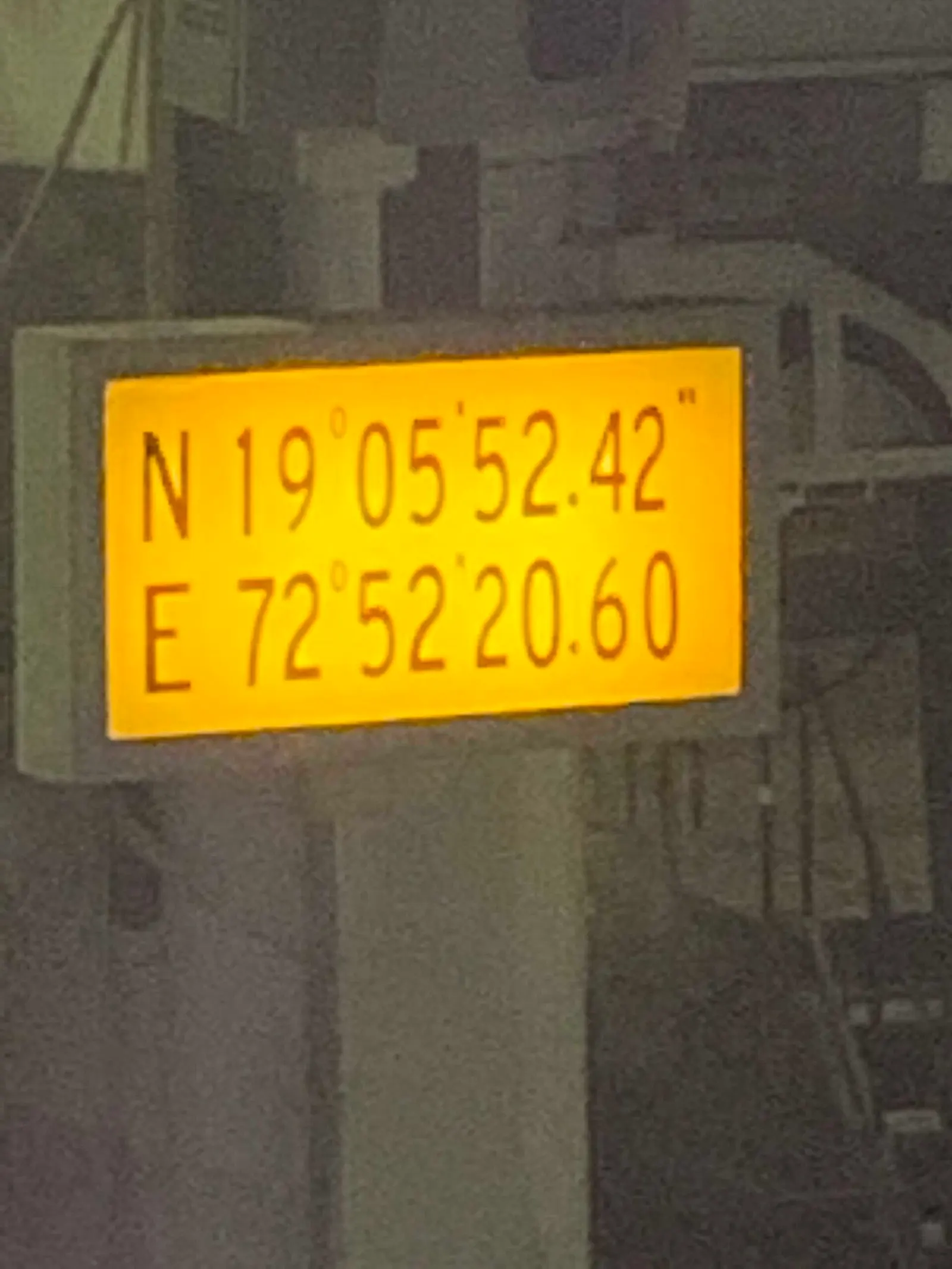 A wall-mounted sign at Terminal 2 gate 81 lists the gate number, GPS coordinates, and location details in multiple languages.