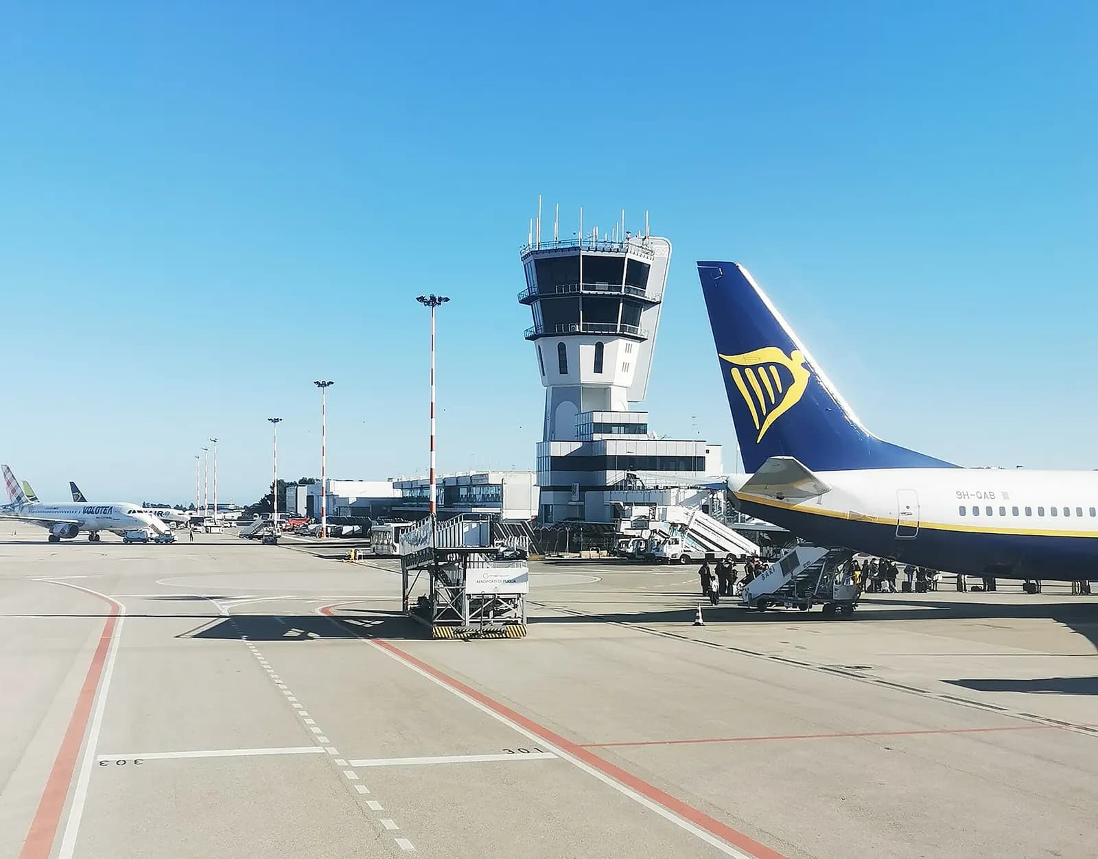 Wide view of Bari Airport terminal buildings and landside access in December 2023