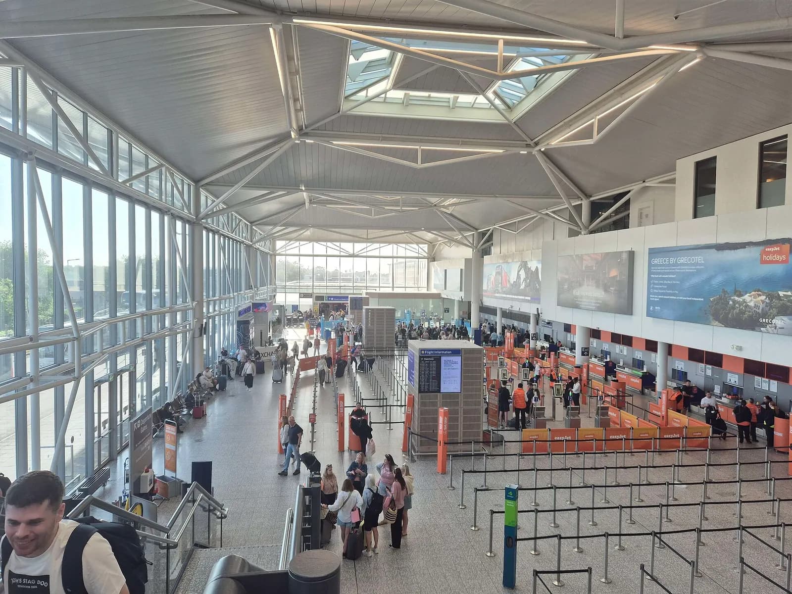 Overhead view of Bristol Airport check-in hall desks and queue lines in June 2025