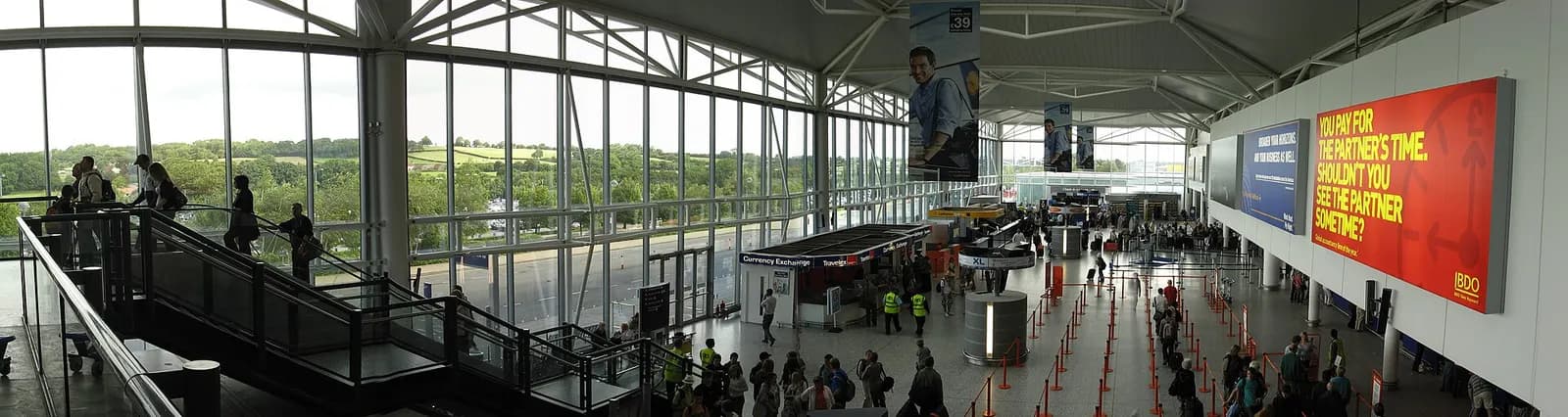 Interior of Bristol Airport terminal departure area with seating and glass frontage