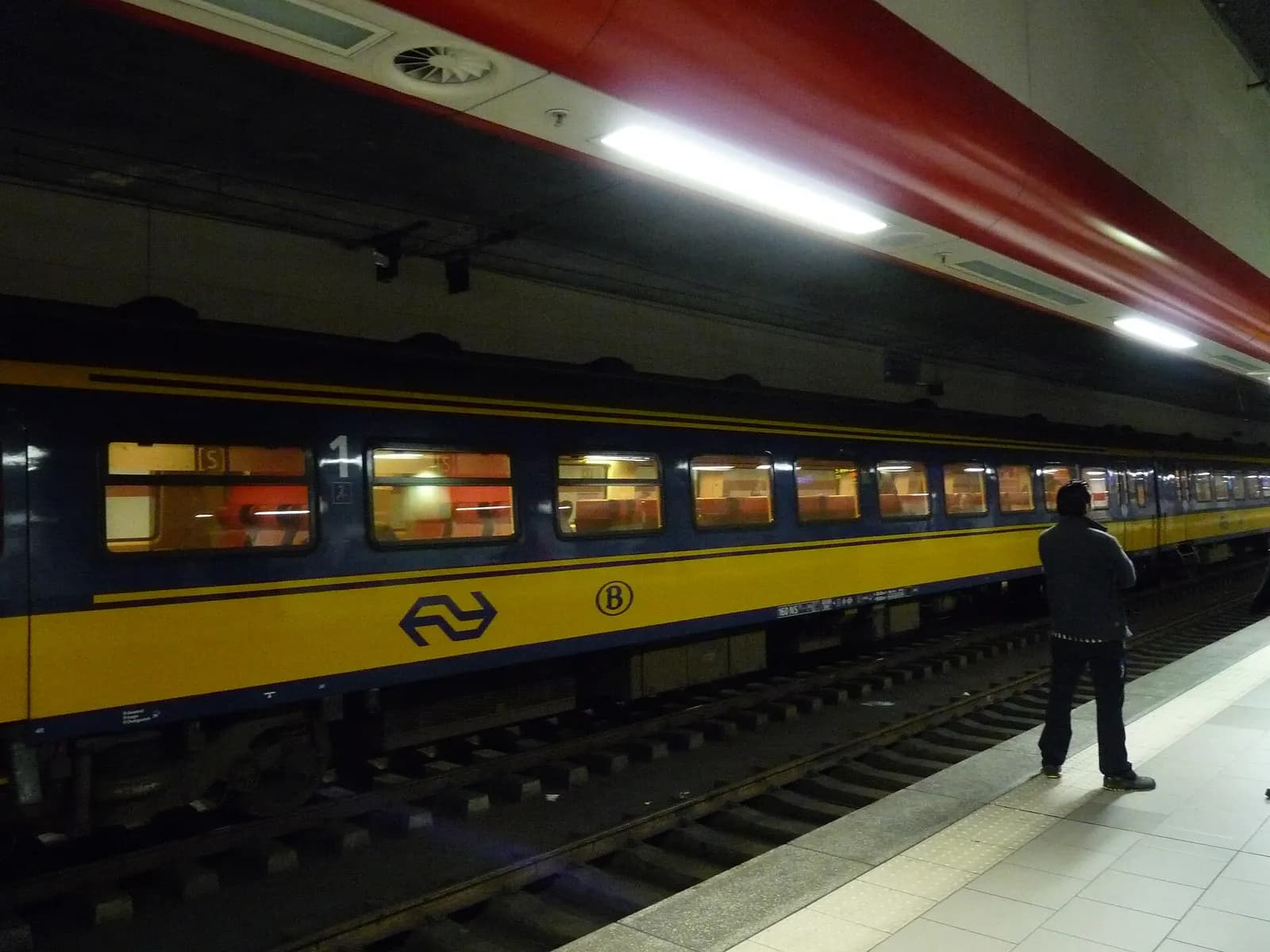 A Benelux intercity train stopped at the platform of Brussels Airport's underground railway station.