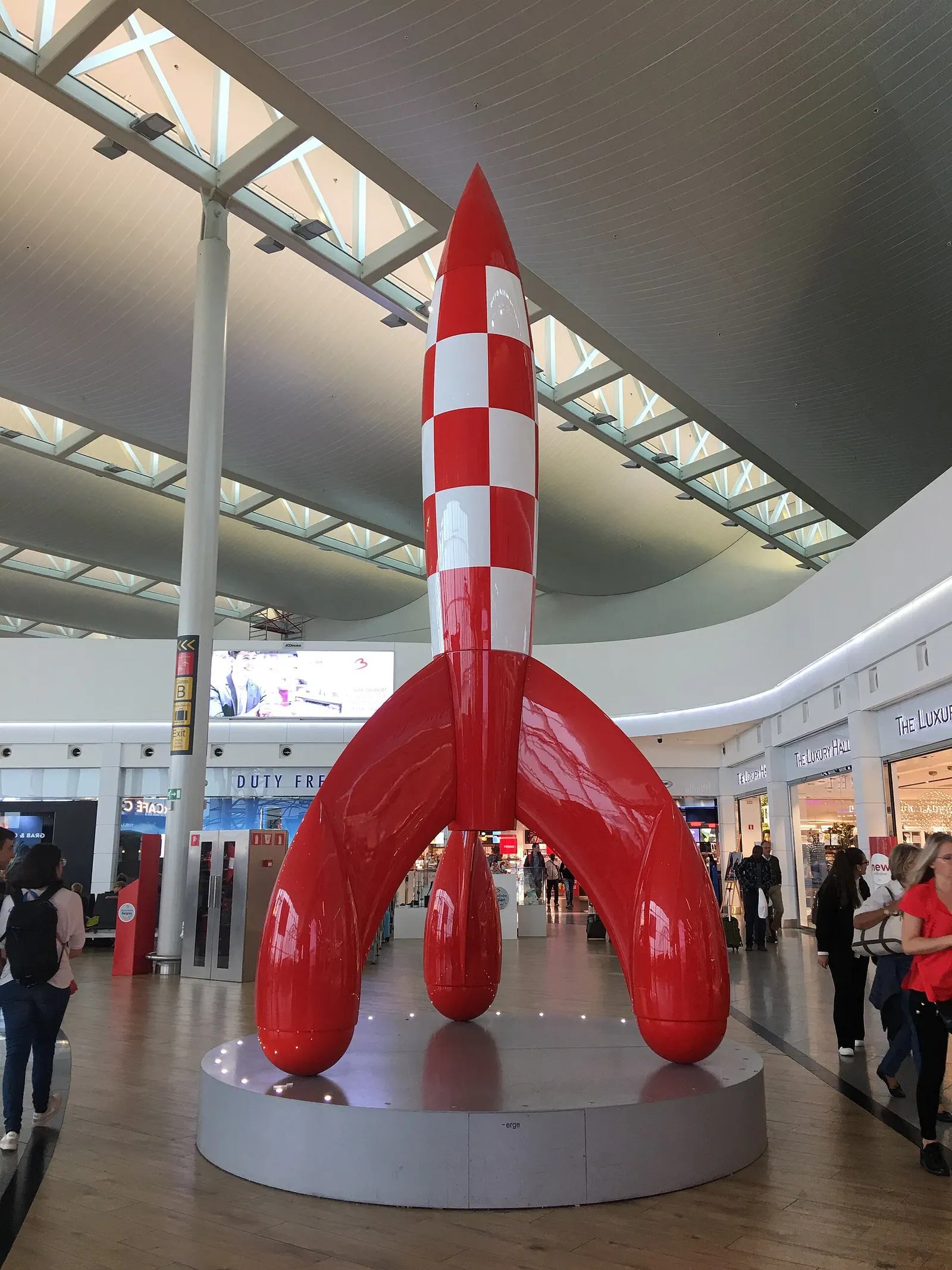A large model of Tintin's red-and-white rocket on display inside Brussels Airport as a Belgian cultural landmark.