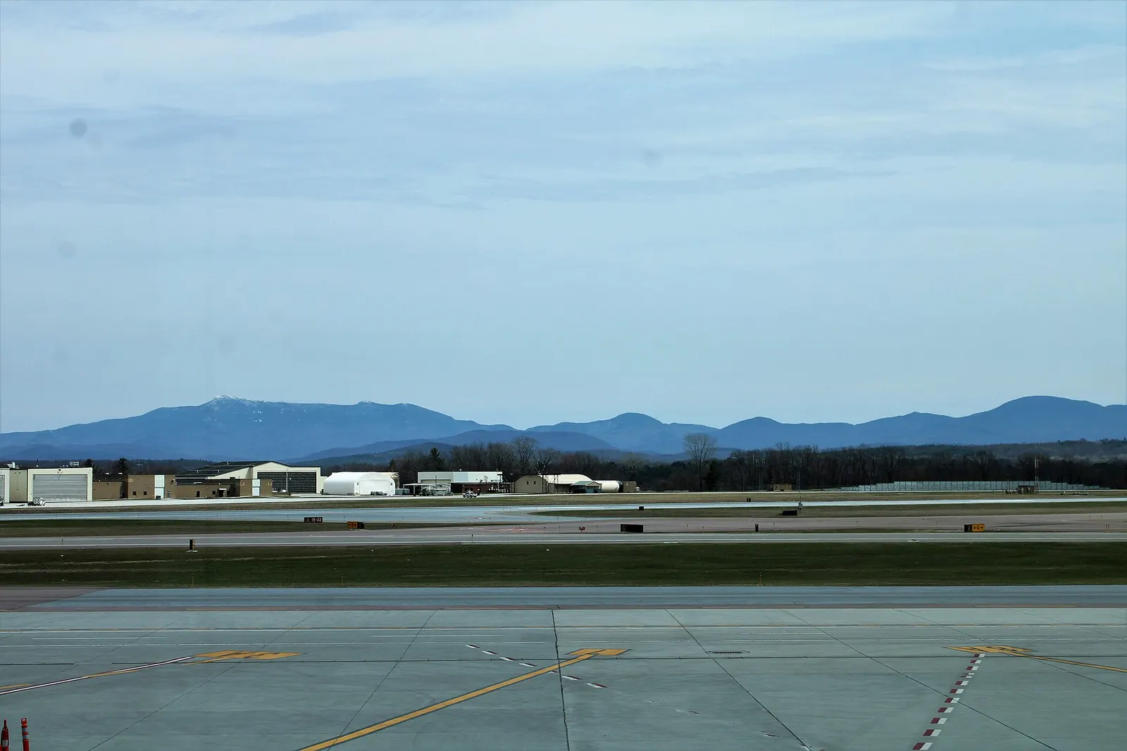 Civil airfield and Green Mountains beyond the passenger apron at Burlington International Airport.