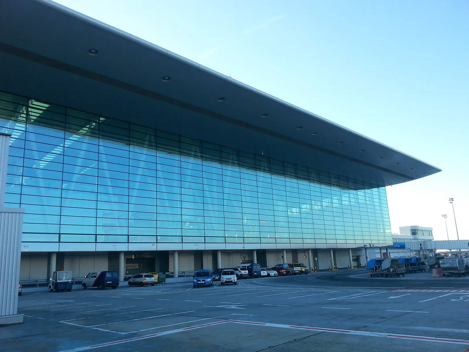 Exterior view of the SkyCourt expansion at Budapest Airport, showing the modern glass-and-steel facade of Terminal 2.