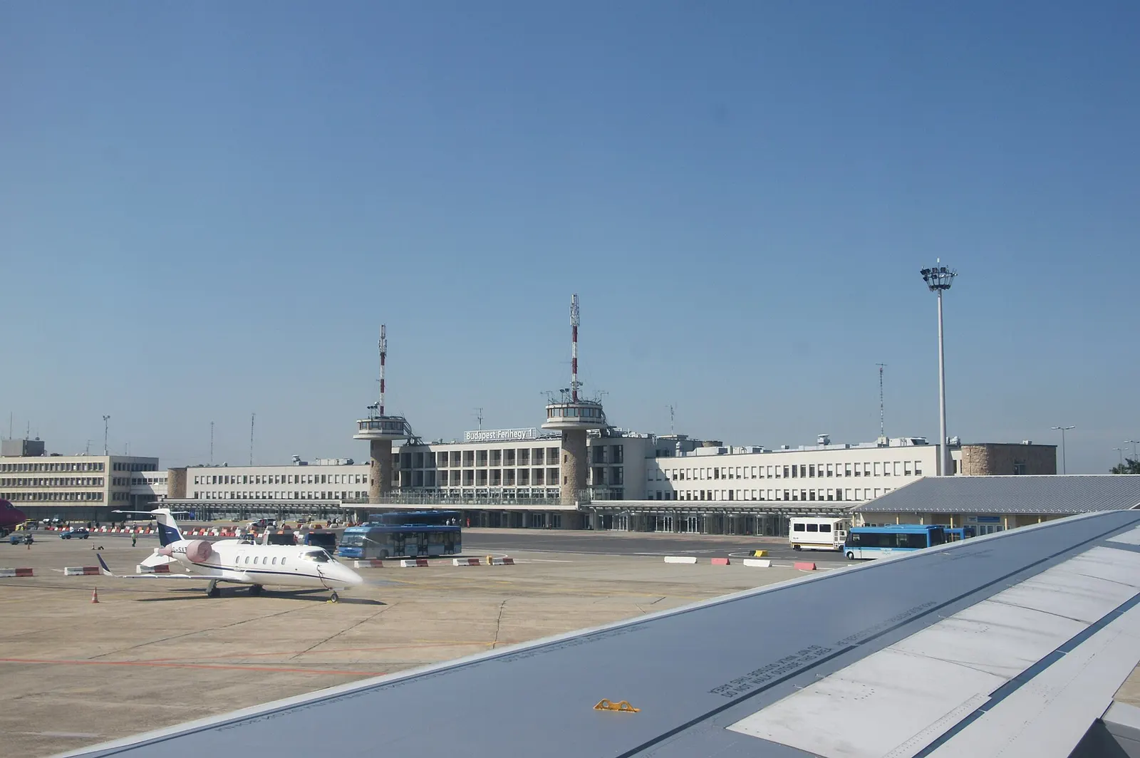 A wide exterior view of Ferihegy International Airport showing the terminal buildings and surrounding airfield infrastructure.