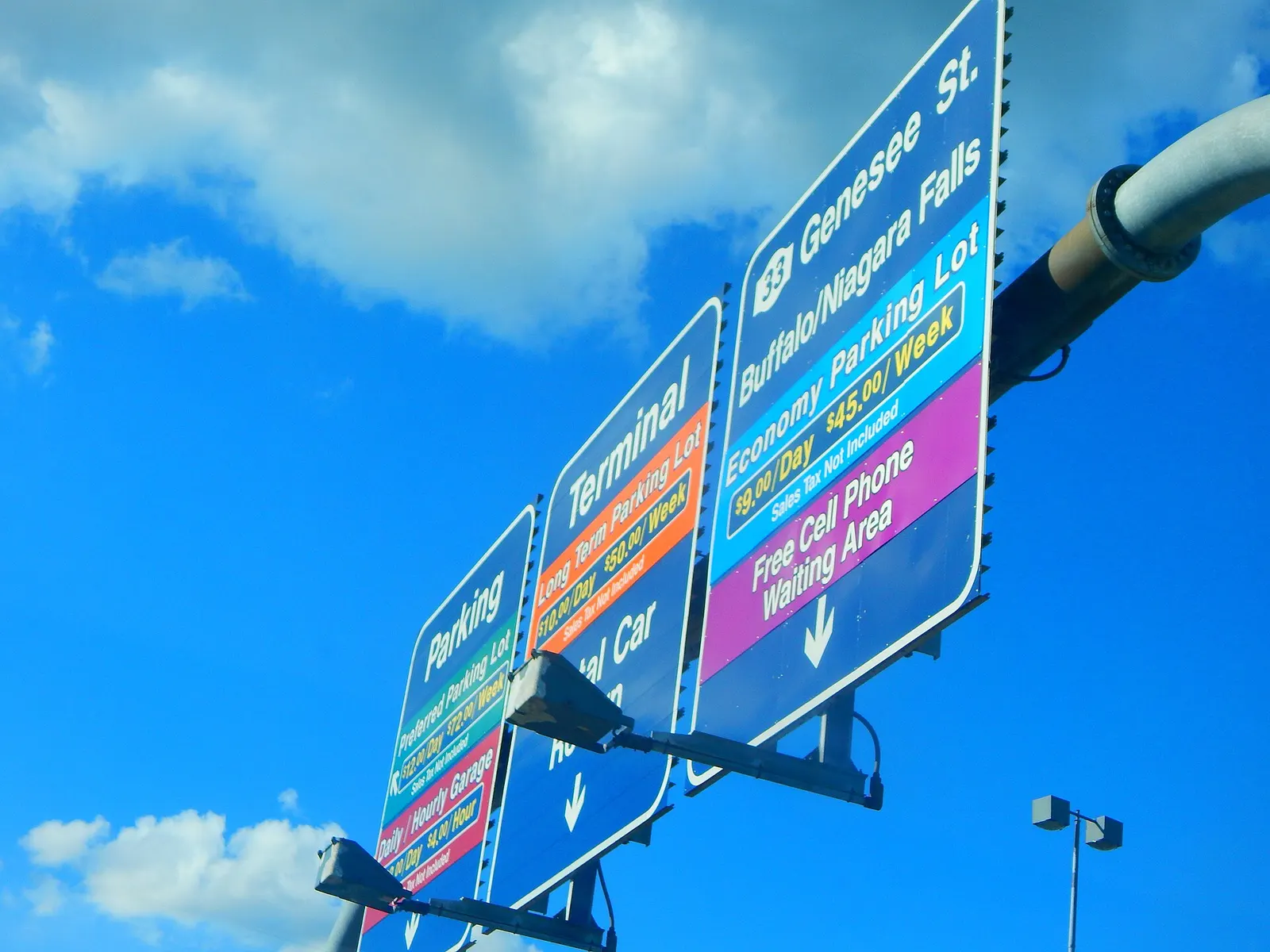 Overhead NY-33 / Genesee Street gantry at BUF color-coding Economy, Preferred, Long Term, garage, rental-car return, and the free cell-phone waiting area.