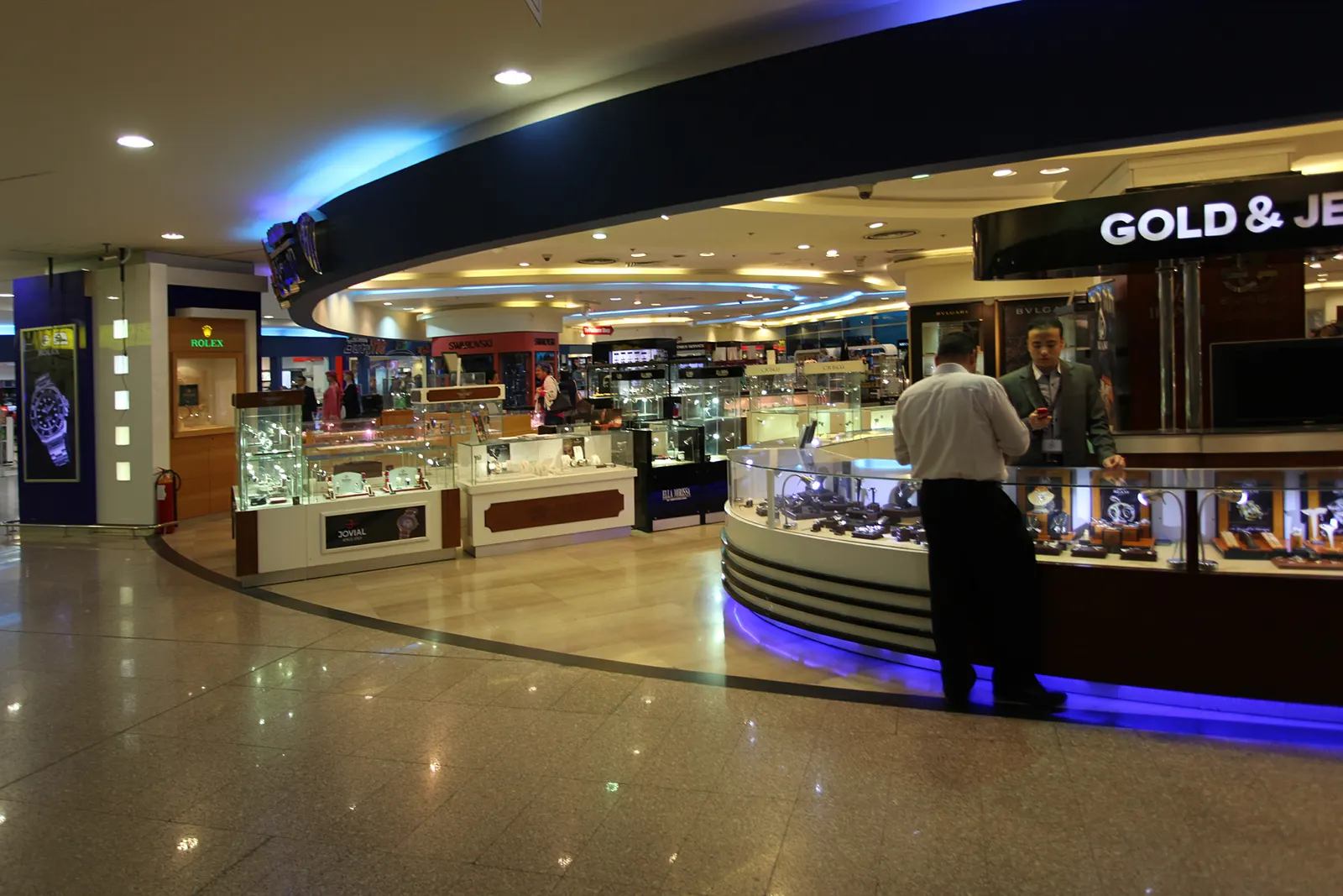 Shoppers browsing duty-free retail displays in the concourse of Terminal 3 at Cairo International Airport.