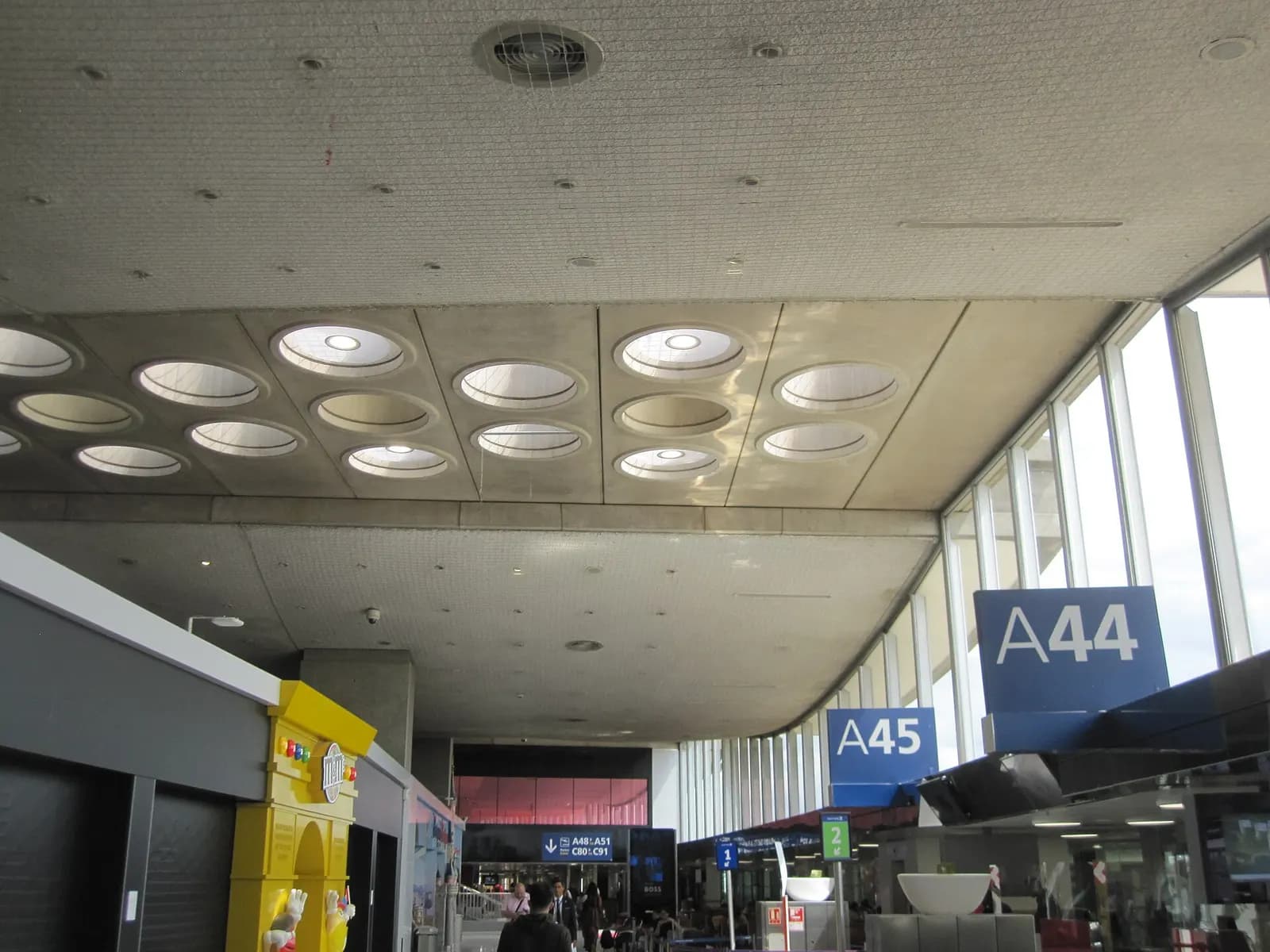 Departure gates A44 and A45 with seating, signage, and flight information displays in Terminal 2A.