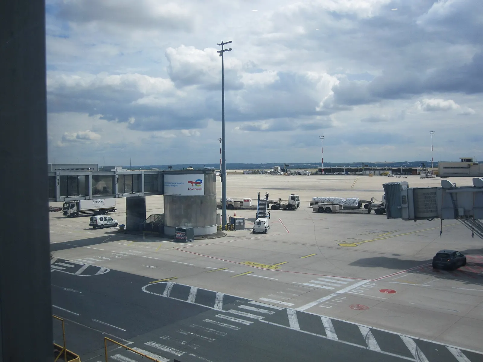 A jet bridge extending from Terminal 2A to an aircraft parked on the tarmac.