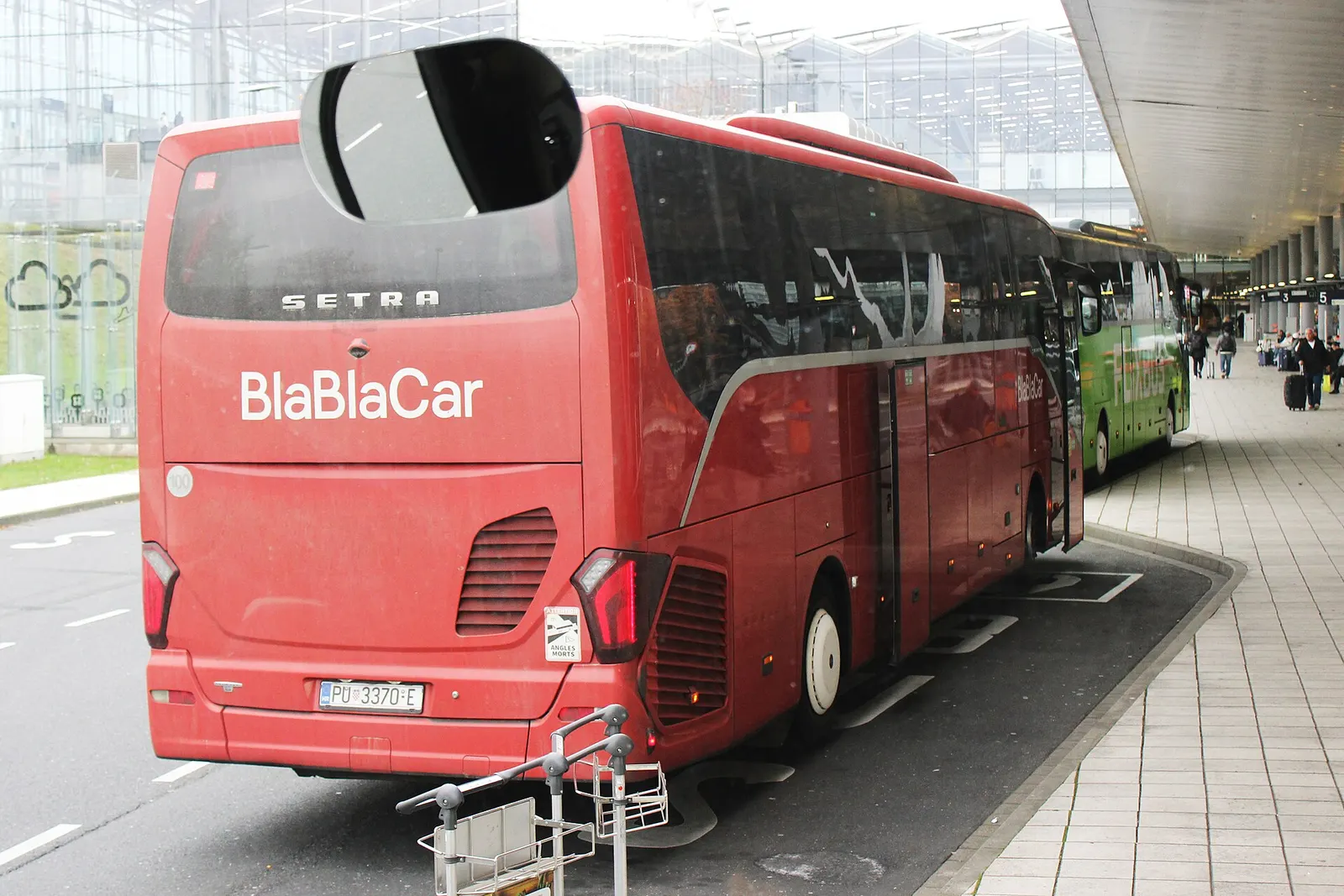 A BlaBlaCar Bus parked at the designated bus stop outside Cologne Bonn Airport.
