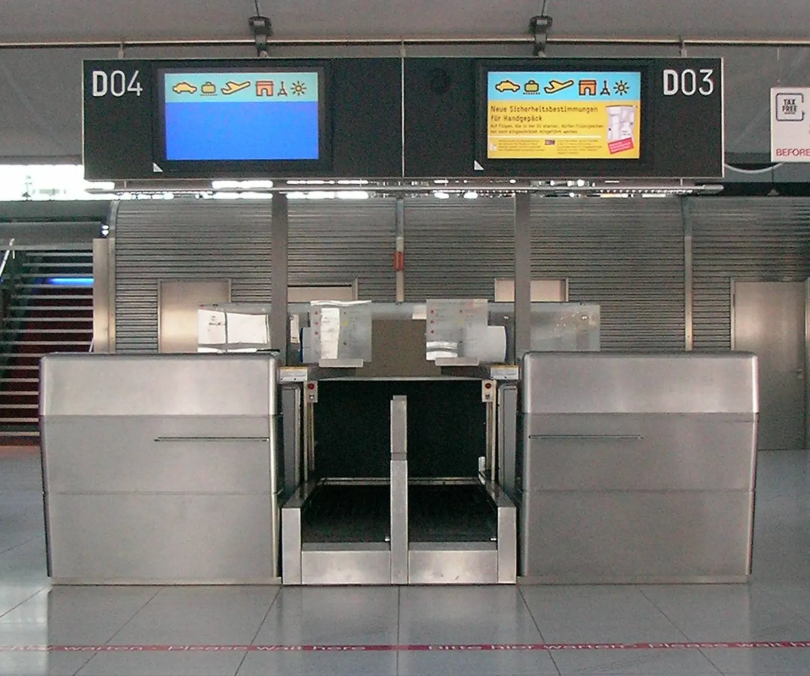 A row of check-in counters with airline signage in the departures hall at Cologne Bonn Airport.