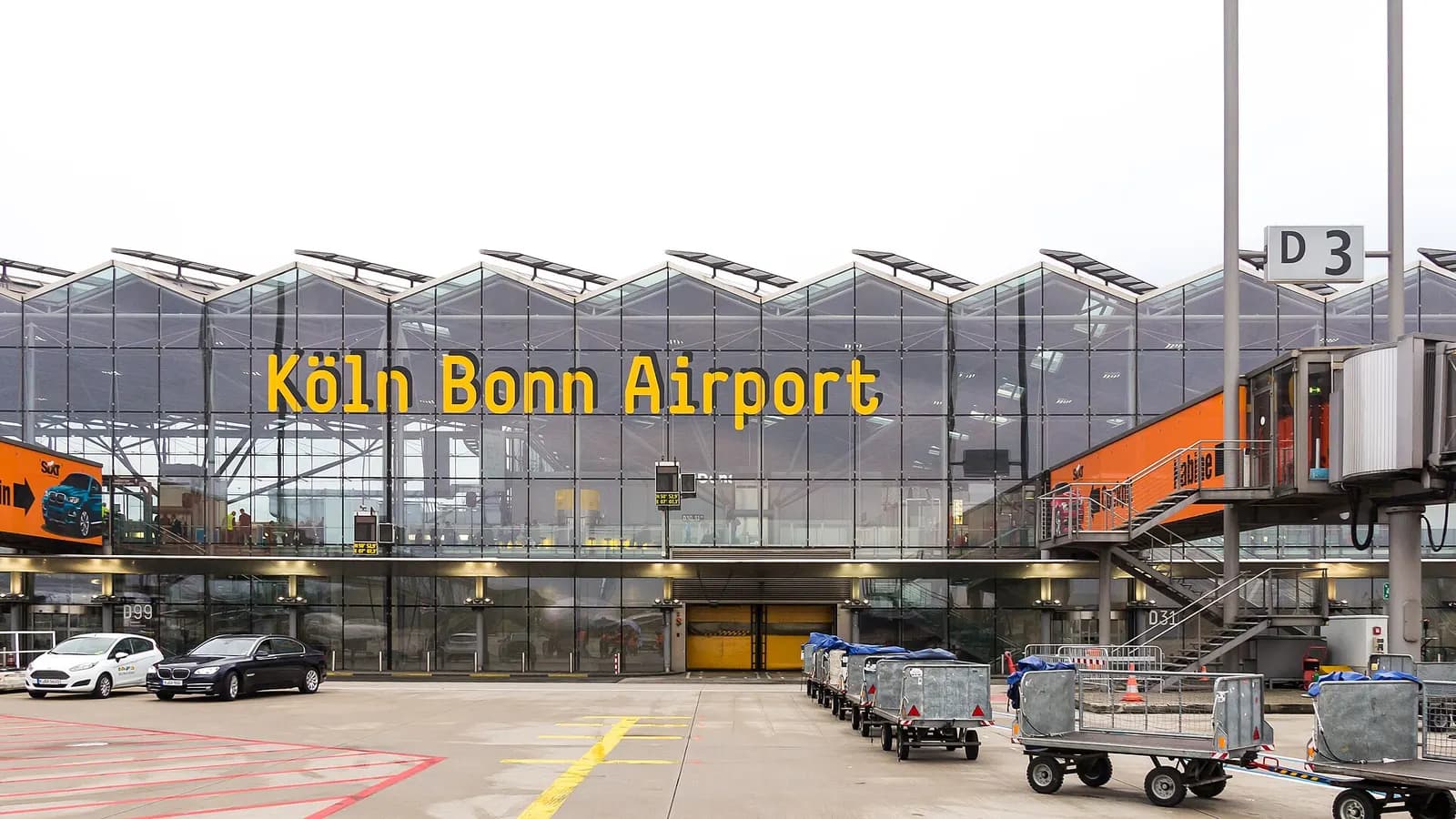 Passenger boarding gates and jet bridges along the Terminal 2 ramp at Cologne Bonn Airport.