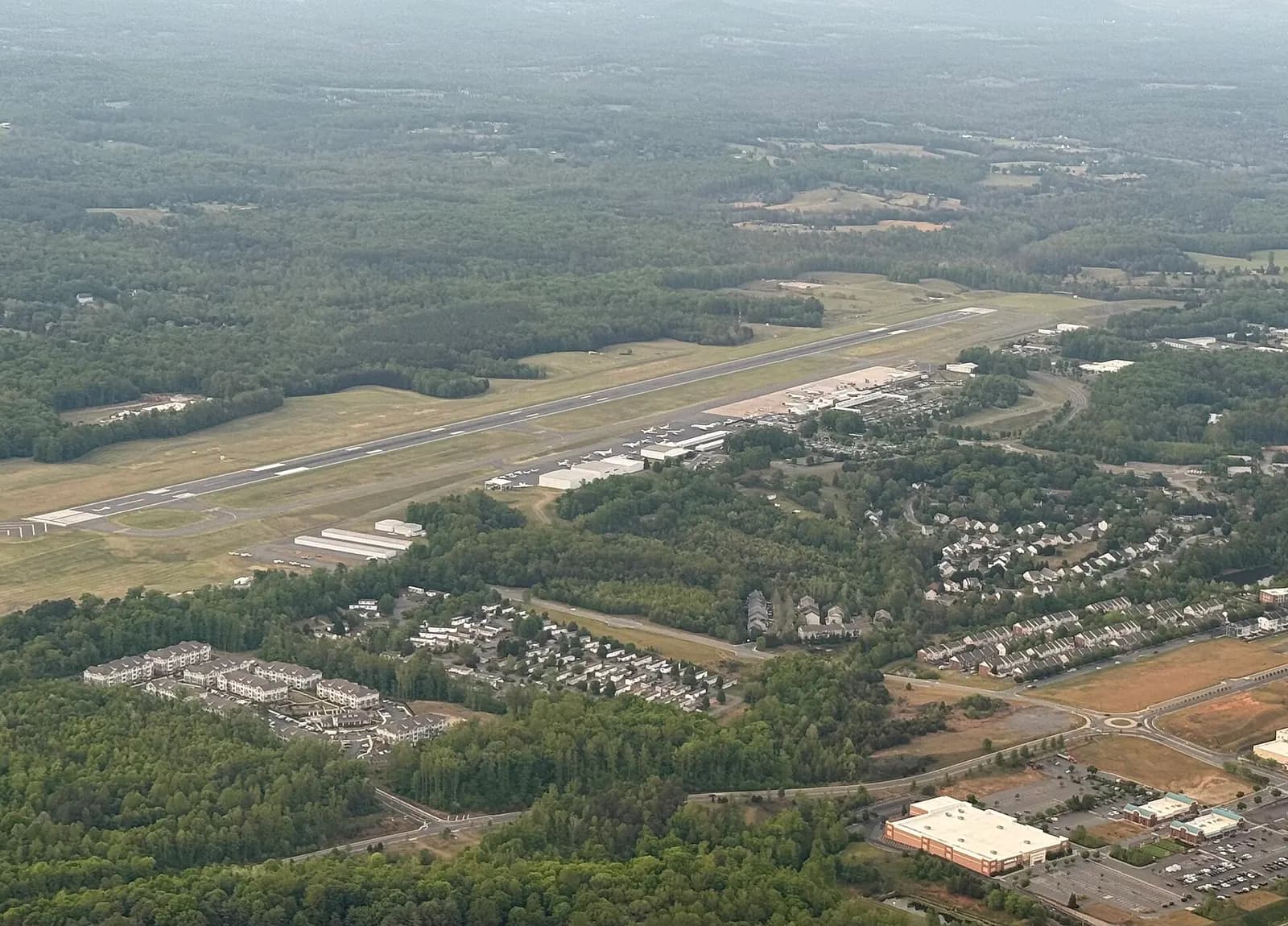 Aerial view of Charlottesville Albemarle Airport (CHO) looking over the single runway and terminal campus