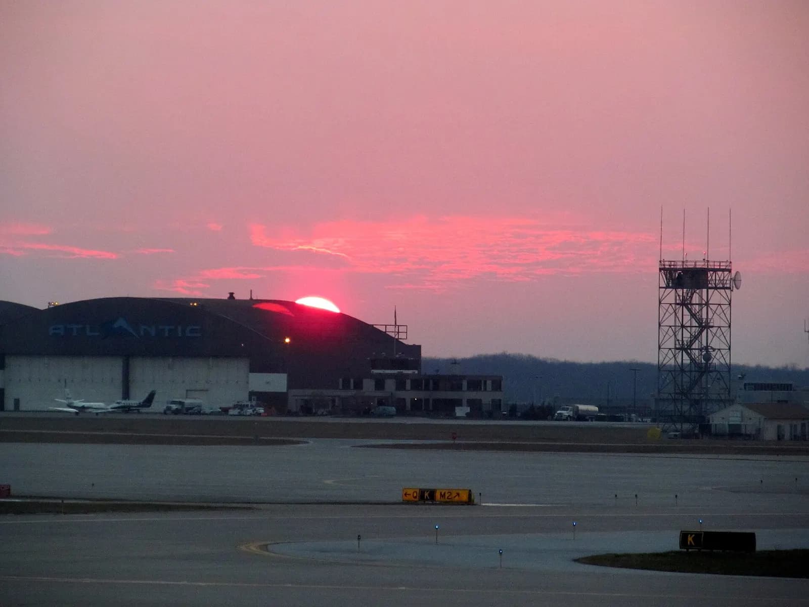 The sun sets over a hangar at Cleveland's airport