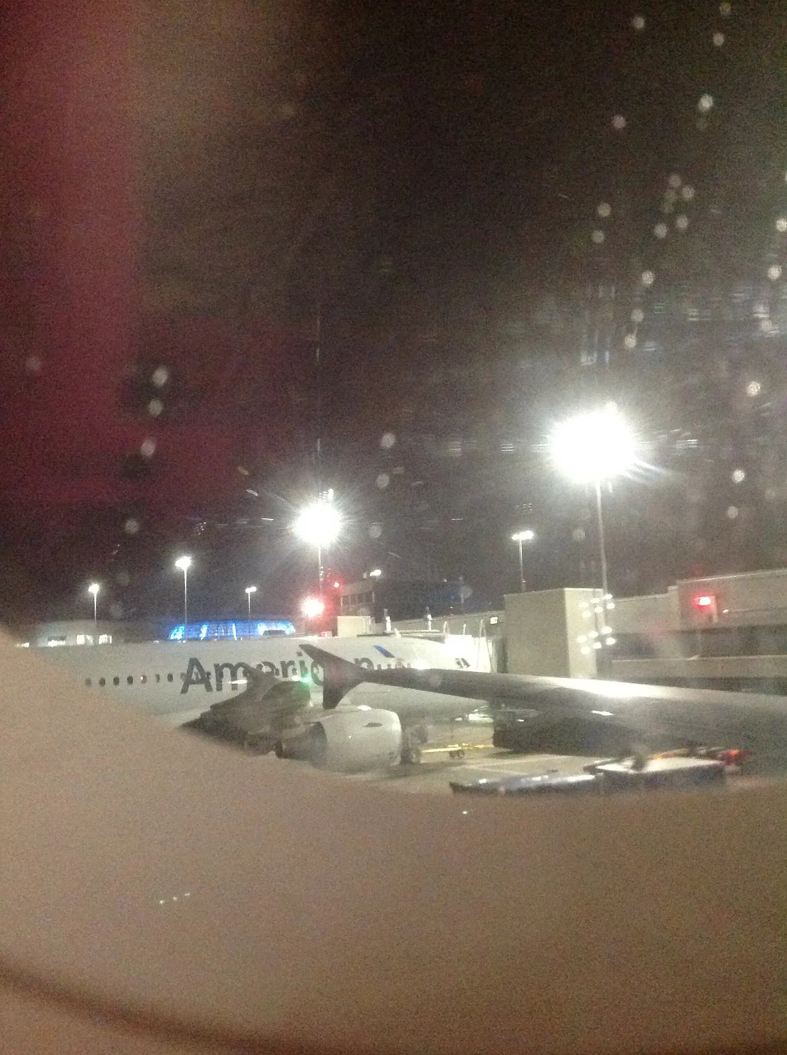 An American Airlines Airbus A319 parked at a jet bridge gate at Charlotte Douglas International Airport.