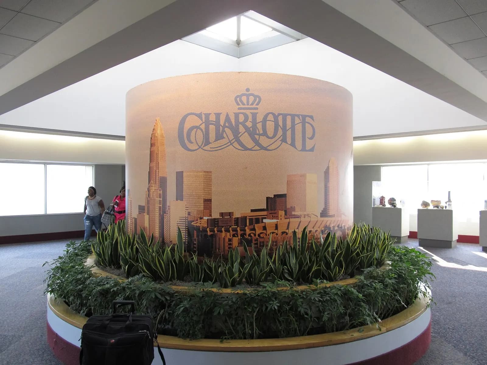 A Welcome to Charlotte sign displayed inside Charlotte Douglas International Airport near the passenger terminal.