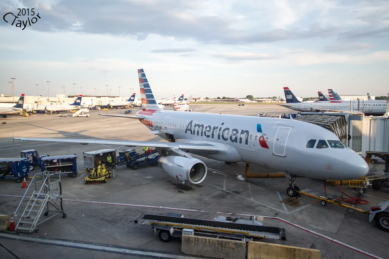 A view from inside the terminal between Concourses B and C looking out through large windows at aircraft parked on the ramp.